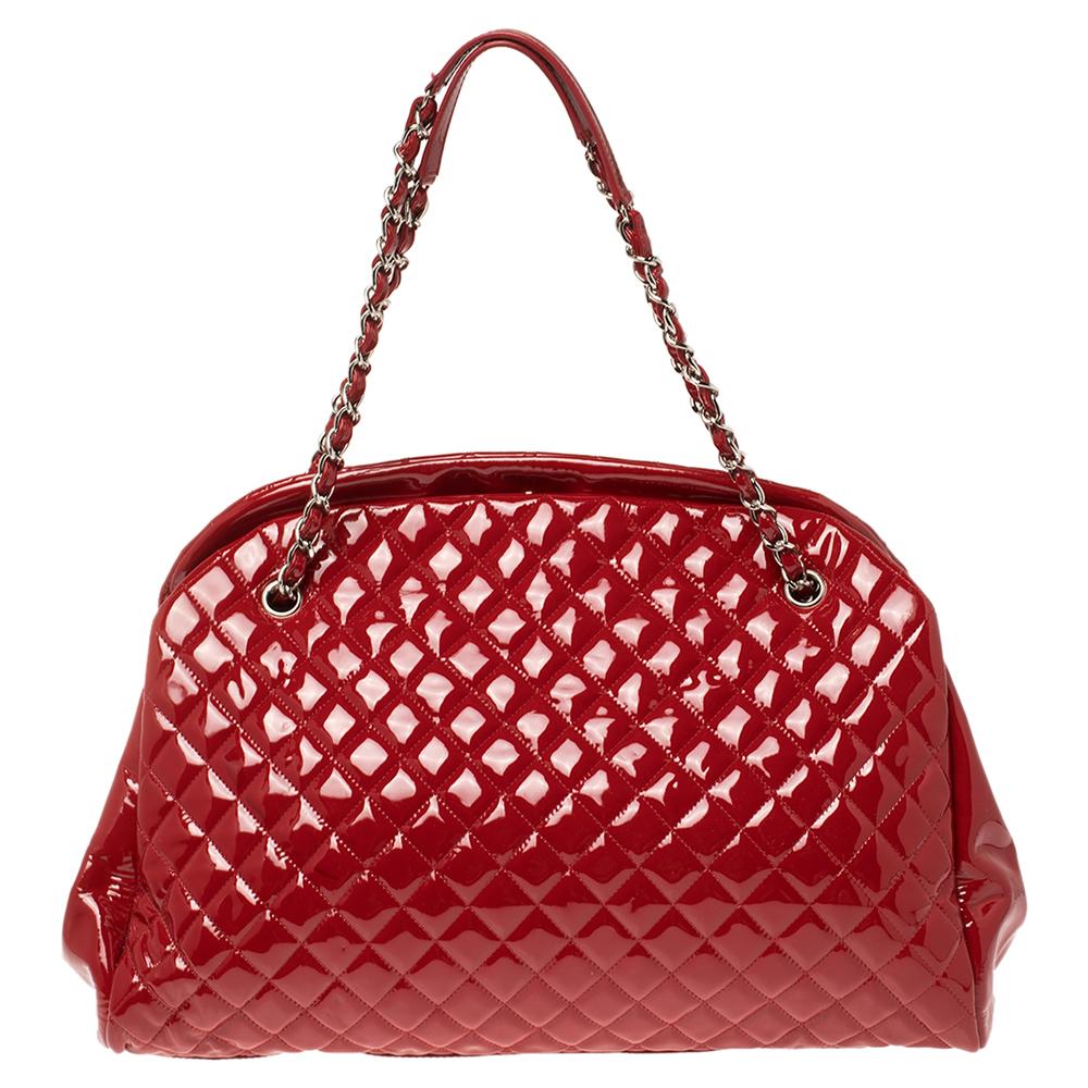 Spacious and captivating, this Just Mademoiselle Bowler bag is from Chanel. It has been crafted from quilted patent leather and features a lovely shape and design. It is equipped with two chain handles and well-sized fabric compartments to keep your
