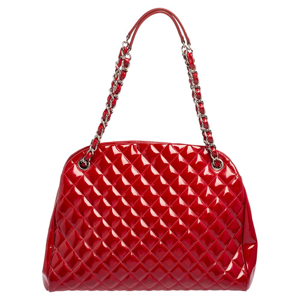 Spacious and captivating, this Just Mademoiselle Bowler bag is from Chanel. It has been crafted from patent leather and features the iconic quilted pattern. It is equipped with two chain handles and well-sized fabric compartments to keep your