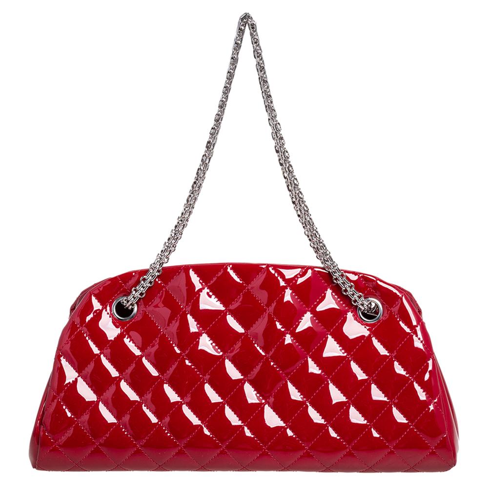 Spacious and captivating, this Just Mademoiselle Bowling bag is from Chanel. It has been crafted from red patent leather and features the iconic quilted pattern. It is equipped with two chain and leather woven handles and a well-sized interior to
