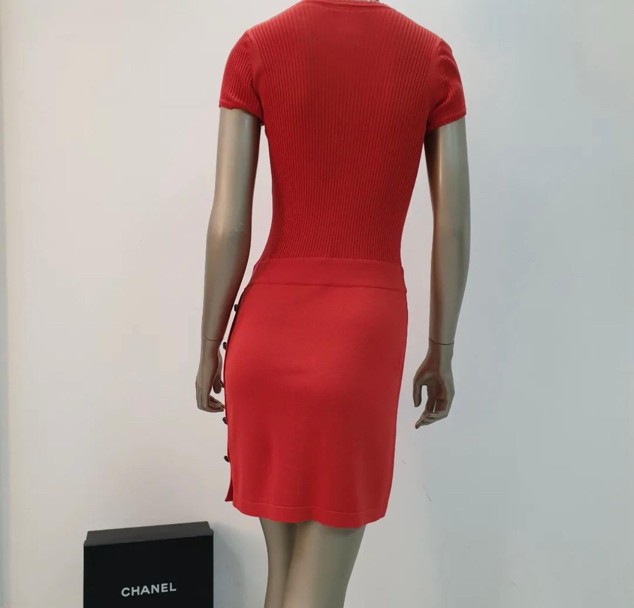  Red dress Chanel with logo in front and buttons on the side.
Sz.36
Very good condition.