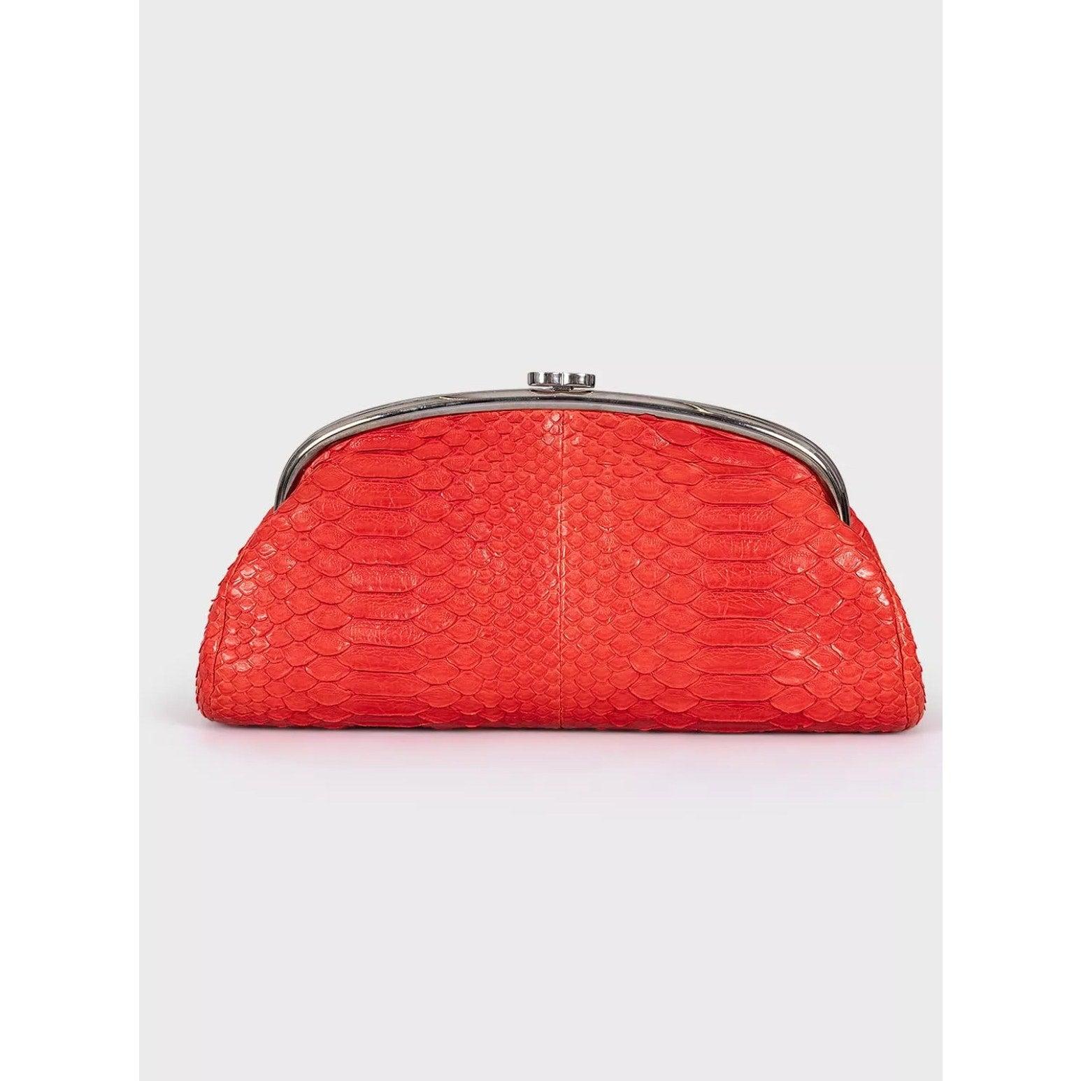 Absolutely stunning Chanel clutch bag, a true collector's item! This exquisite piece was expertly crafted in France from genuine snakeskin leather, showcasing a vibrant red hue that is sure to turn heads. 

The bag features:
- Smooth leather lining