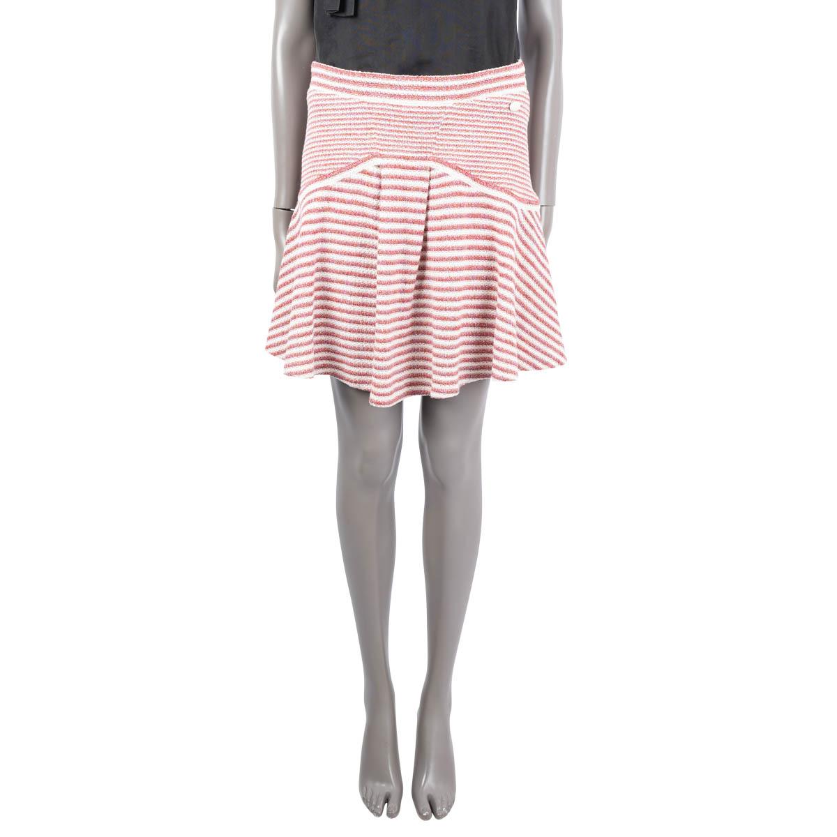 100% authentic Chanel flared knit skirt in red and off-white striped paper (41%), cotton (31%) and silk (28%). Features a glossy button on the waist. Opens with a concealed zipper on the side and is lined in silk (with 14% spandex). Has been worn