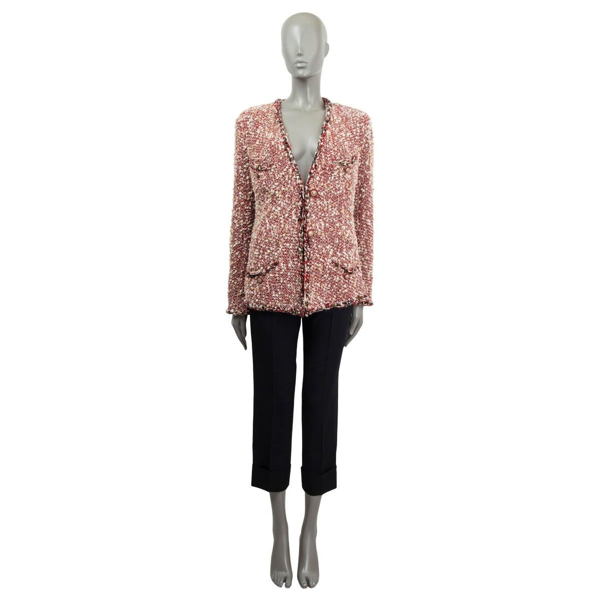 100% authentic Chanel collarless tweed jacket in red and white wool (71%), nylon (25%), acrylic (2%) and cotton (2%). Features a V-neck, braided trim with star studs and four pockets on the front. Closes with two start buttons. Lined in red silk
