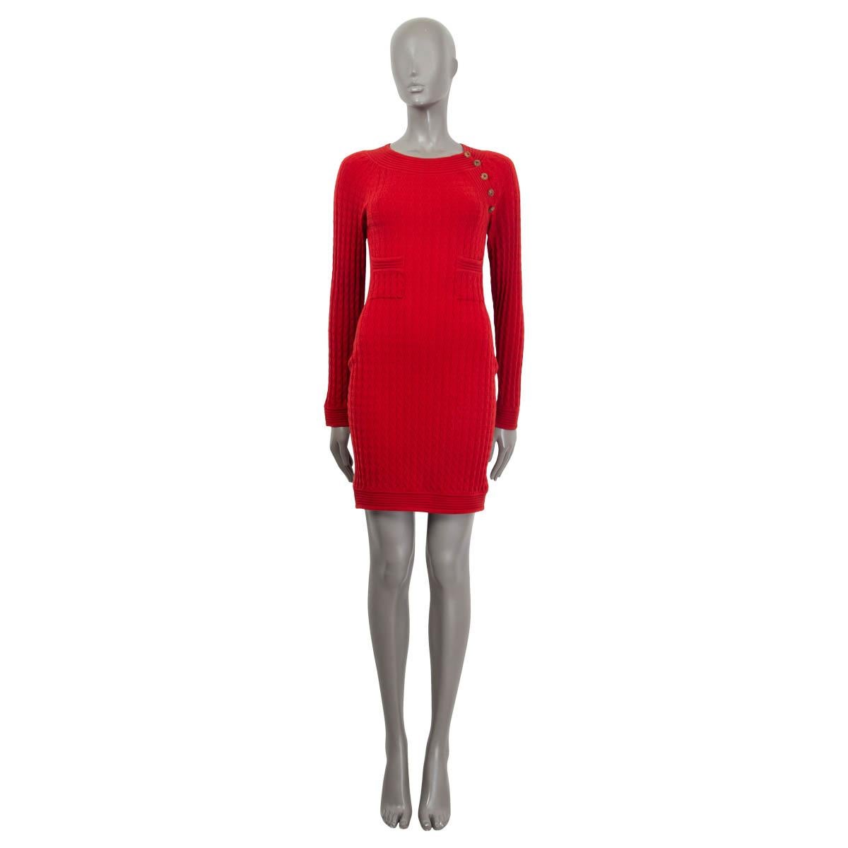 100% authentic Chanel Metiers D'Art 2010 Paris-Shanghai knit dress in red wool (87%) and polyester (13%). Features two patch pockets on the front and long raglan sleeves (sleeve measurements taken from the neck). Opens with five 'CC' buttons on the