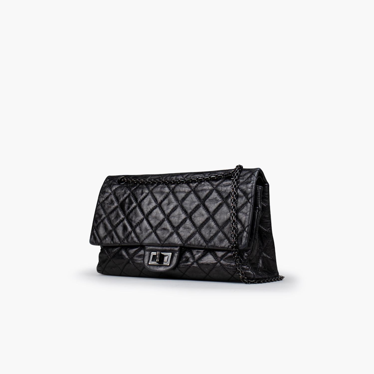 Black metallic Chanel Reissue 227 Double Flap Bag

- Black-tone hardware
- Convertible Venetian chain-link shoulder strap
- Single exterior patch pocket at back
- Single zip pocket at flap underside, three interior compartments; two with snap