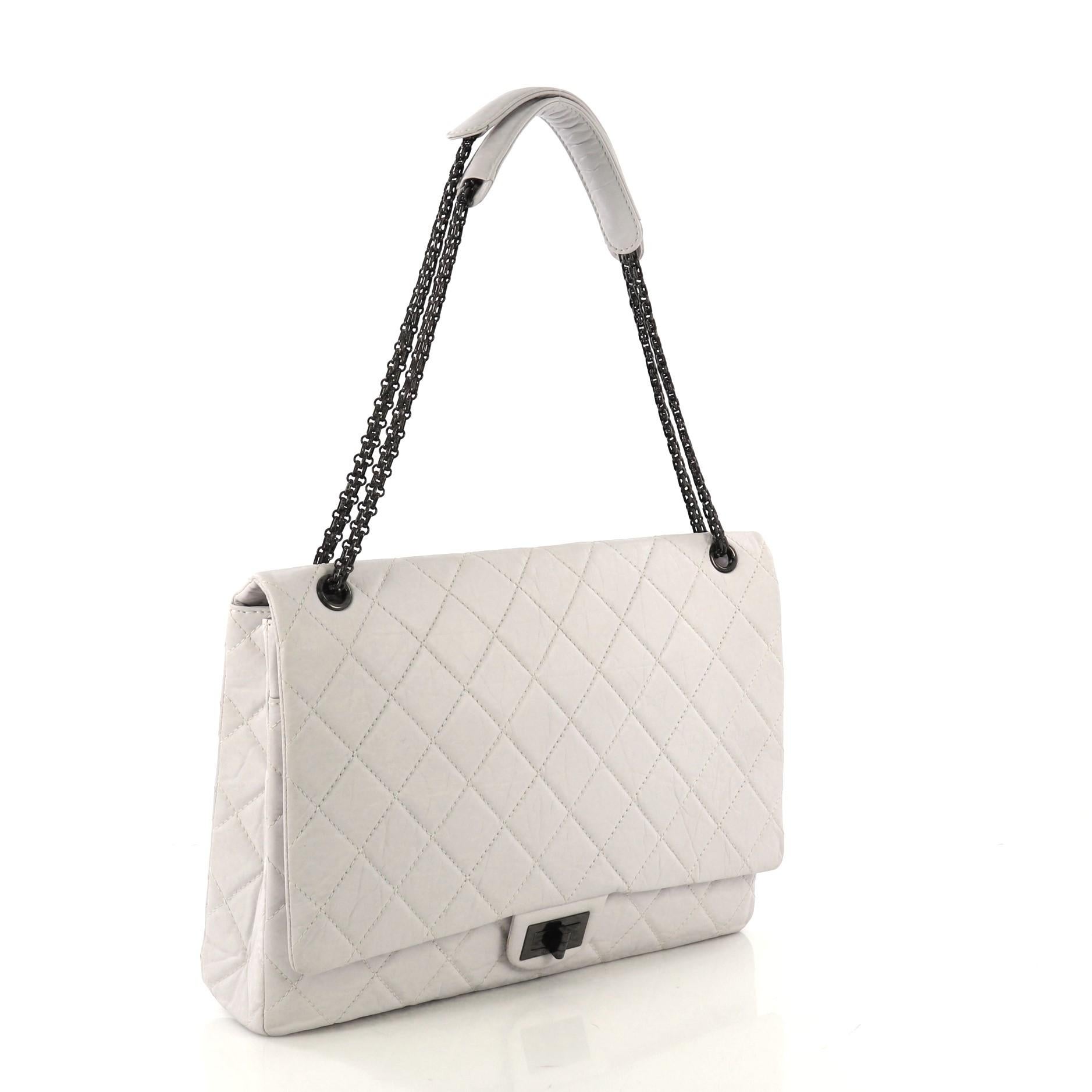 This Chanel Reissue 2.55 Flap Bag Quilted Aged Calfskin XL, crafted from pale gray quilted aged calfskin leather, features reissue chain link strap, exterior back slip pocket, and black-tone hardware. Its mademoiselle turn-lock closure opens to a