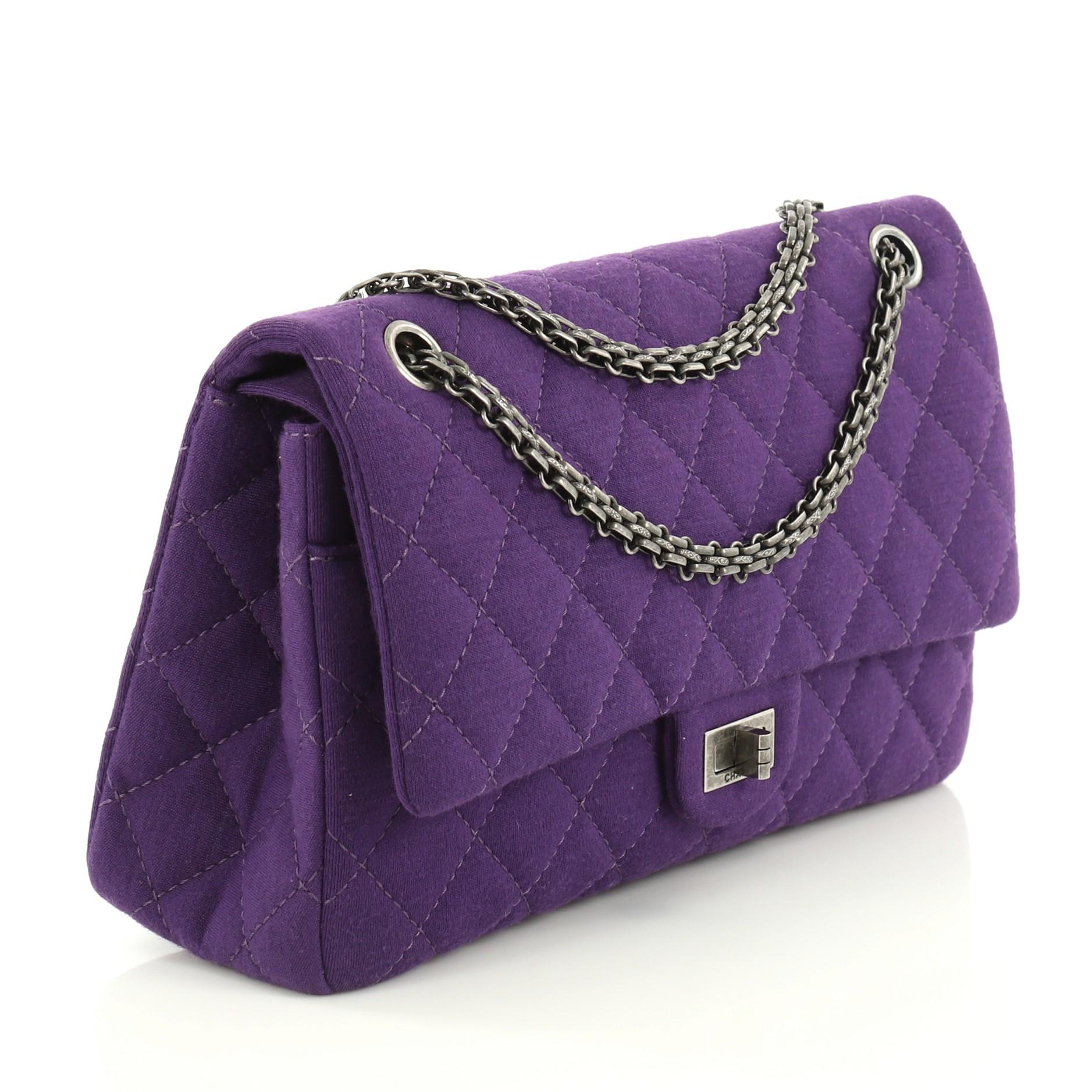 This Chanel Reissue 2.55 Flap Bag Quilted Jersey 226, crafted from purple quilted jersey, features reissue chain link strap, exterior back slip pocket, and aged silver-tone hardware. Its mademoiselle turn-lock closure opens to a purple leather