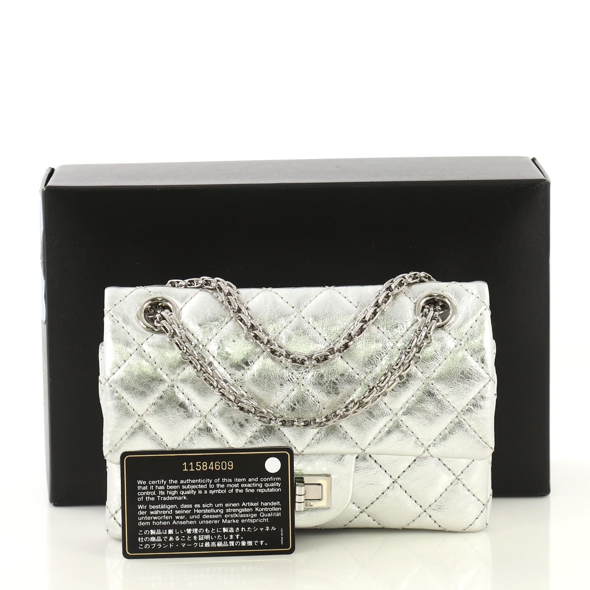 This Chanel Reissue 2.55 Flap Bag Quilted Metallic Aged Calfskin 224, crafted from metallic silver quilted aged calfskin leather, features reissue chain link strap and silver-tone hardware. Its mademoiselle turn-lock closure opens to a metallic