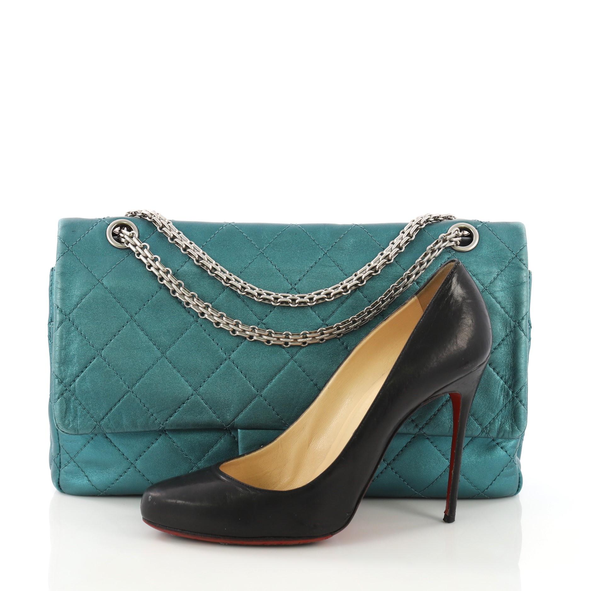 This Chanel Reissue 2.55 Handbag Quilted Metallic Aged Calfskin 227, crafted in teal quilted metallic aged calfskin, features reissue chain shoulder strap, front flap, and matte silver-tone hardware. Its mademoiselle turn-lock closure opens to a