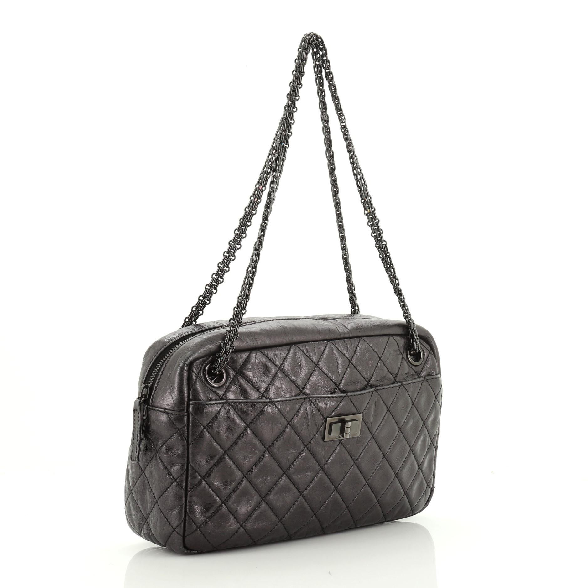 This Chanel Reissue Camera Bag Quilted Aged Calfskin Medium, crafted in black quilted aged calfskin leather, features iconic bijoux chain straps, front pocket with mademoiselle lock closure, exterior back slip pocket and gunmetal-tone hardware. Its