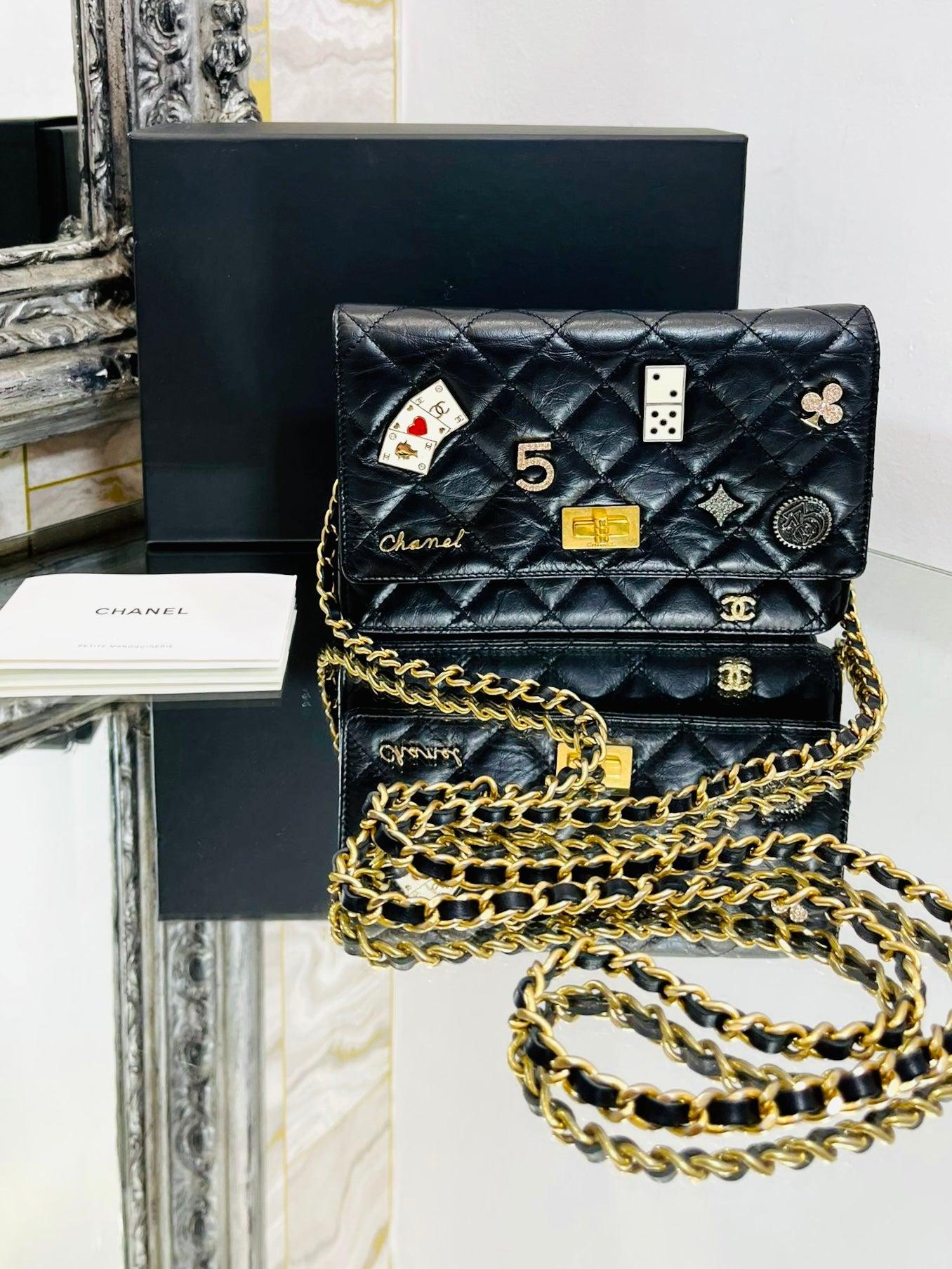 Chanel Reissue Casino Lucky Charms Wallet On A Chain 

Black, quilted, aged, leather with Casino styled and 'CC' logo

badges/charms to the front. Gold hardware and leather and chain

crossbody strap. From 2016 Collection.

Size - Height 13cm, Width