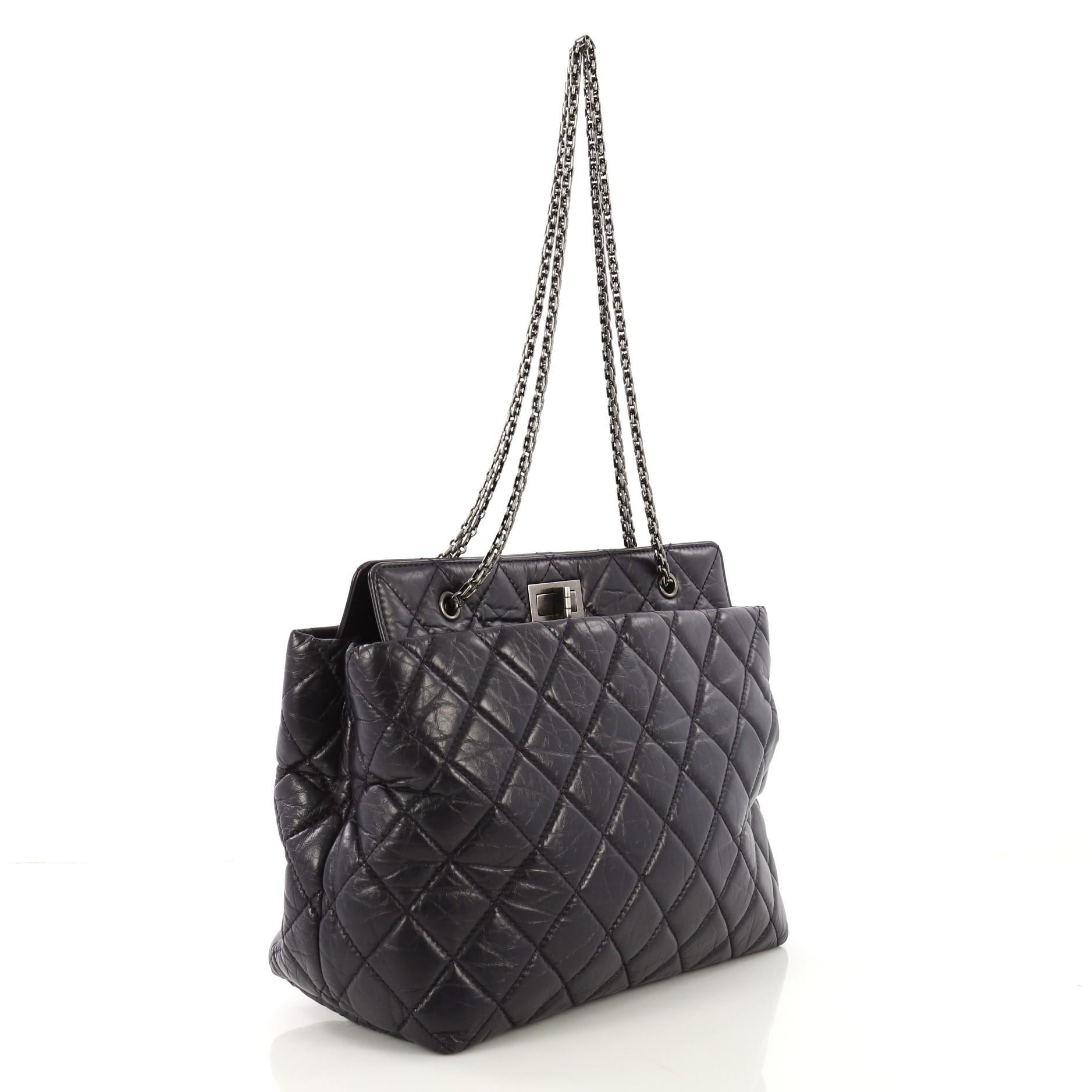 This Chanel Reissue Tote Quilted Aged Calfskin Large, crafted in dark purple quilted aged calfskin leather, features chain link straps and aged gunmetal-tone hardware. Its mademoiselle turn-lock closure opens to a black fabric interior with middle