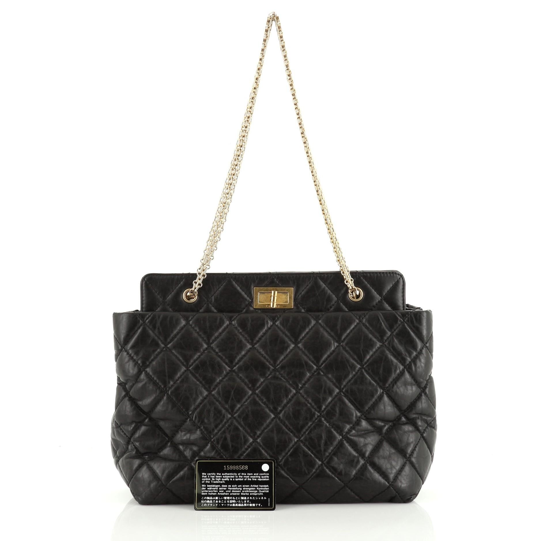 This Chanel Reissue Tote Quilted Aged Calfskin Medium, crafted in black quilted aged calfskin leather, features chain link straps and gold-tone hardware. Its mademoiselle turn-lock closure opens to a black fabric interior with middle zip compartment