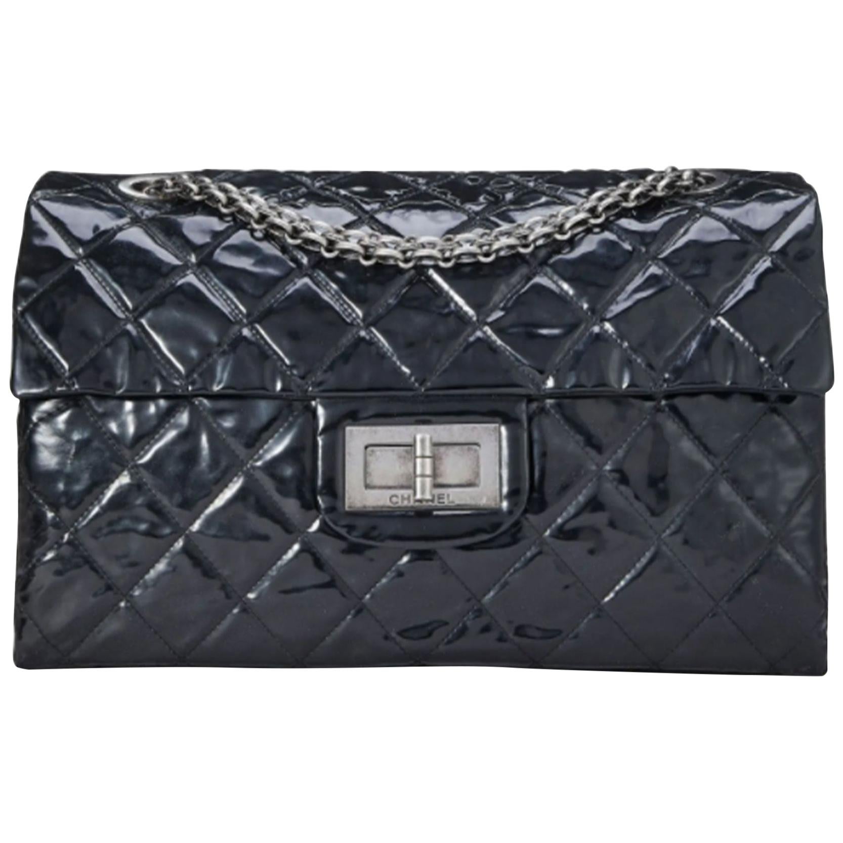Chanel Vintage Black Quilted Patent Leather Reissue Flap Bag XL Shoulder Bag

Spacious carry-all version of the classic Chanel Reissue Flap Bag featured in the XL size, rendered in black quilted patent leather and accented with Ruthenium Venetian