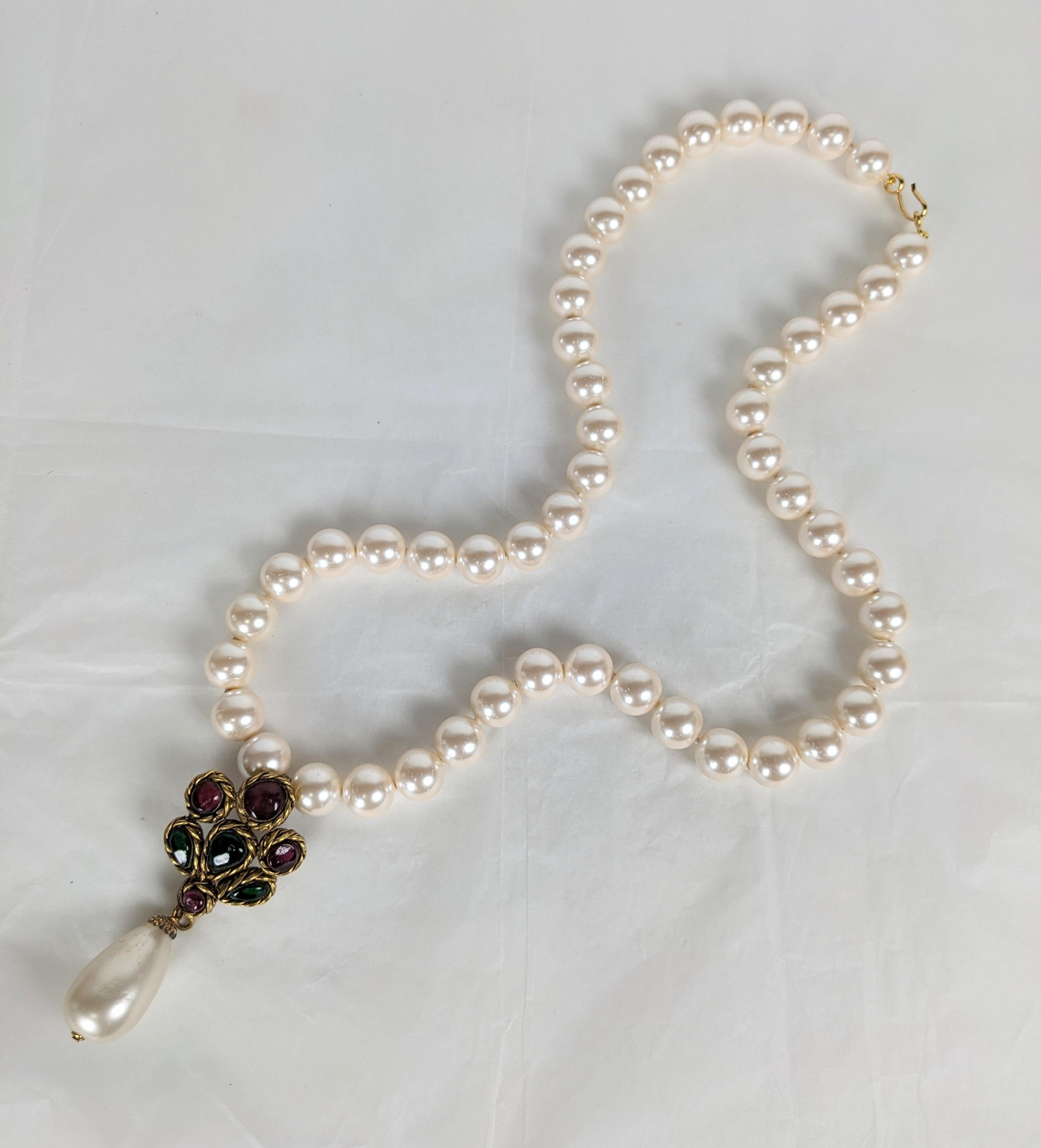 Chanel Renaissance Revival Pearl Pendant, Maison Gripoix by Victoire de Castellane for Chanel. Gripoix hand made poured glass pendant in ruby and emerald glass in bronze settings on a strand of faux pearls. Unsigned runway sample. 24