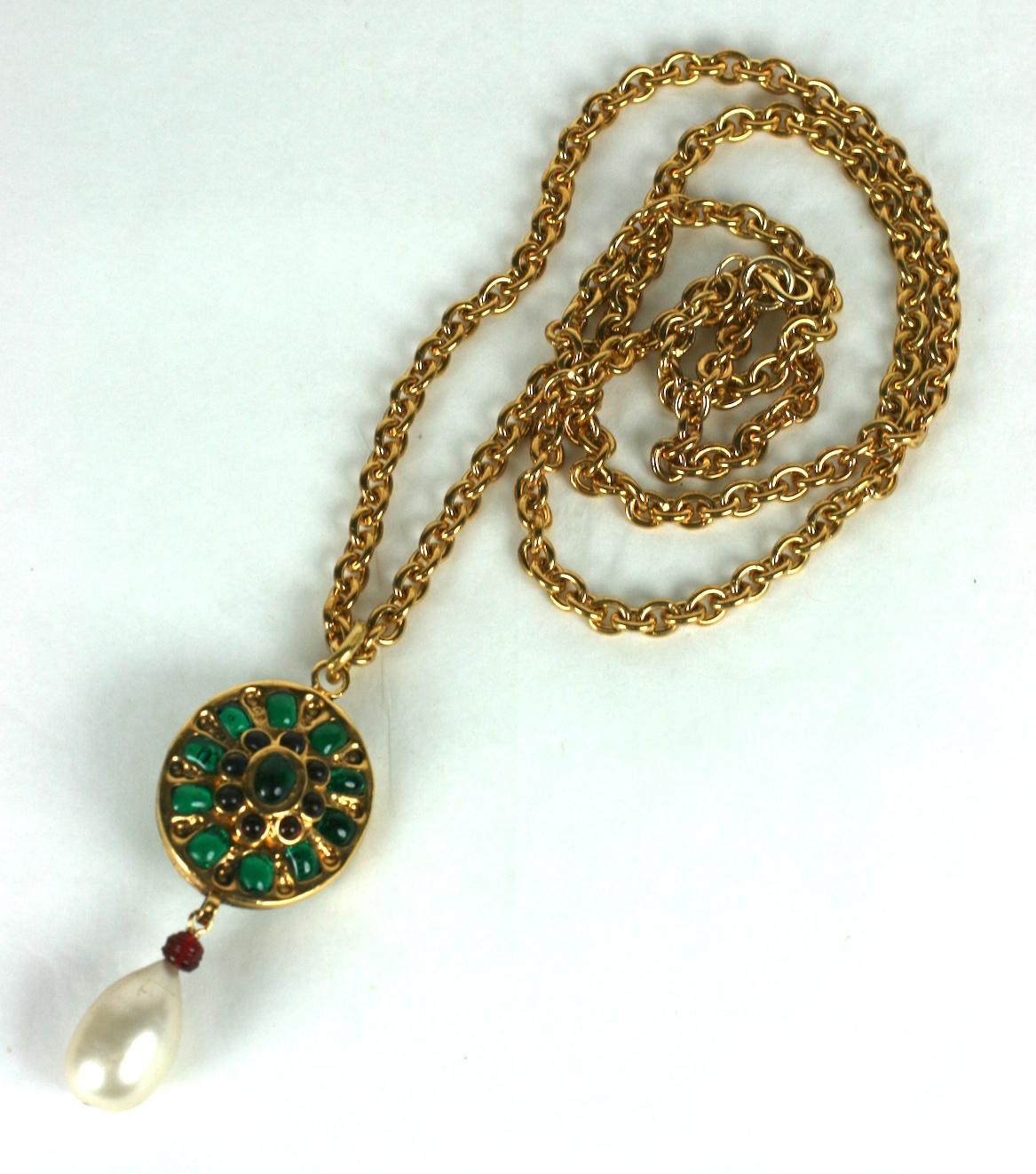 Chanel Renaissance Style Pendant from the 1980's hand made by Maison Gripoix. A reversible double sided oval pendant has poured glass work in emerald and ruby with a faux poured glass nacred pearl on a heavy gilt bronze chain. 
Unsigned runway