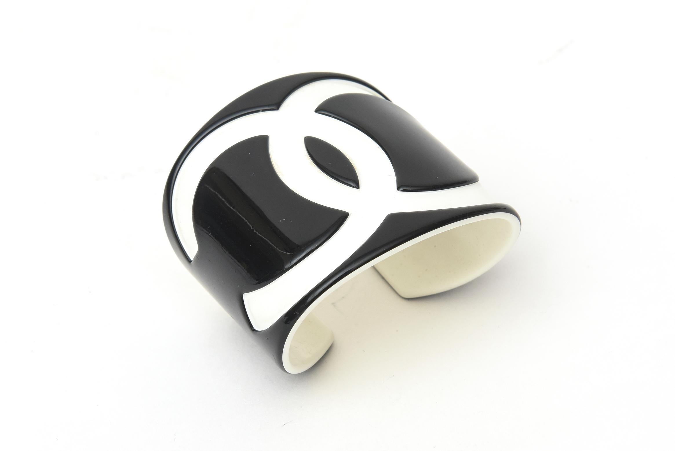 This dramatic black and white CC Chanel resin cuff bracelet is wide and from the 2005. Perfect to welcome in summer of 2020. Black and white is always classic and tres chic. It is fabulous and will always remain as such.  It is light on the wrist.