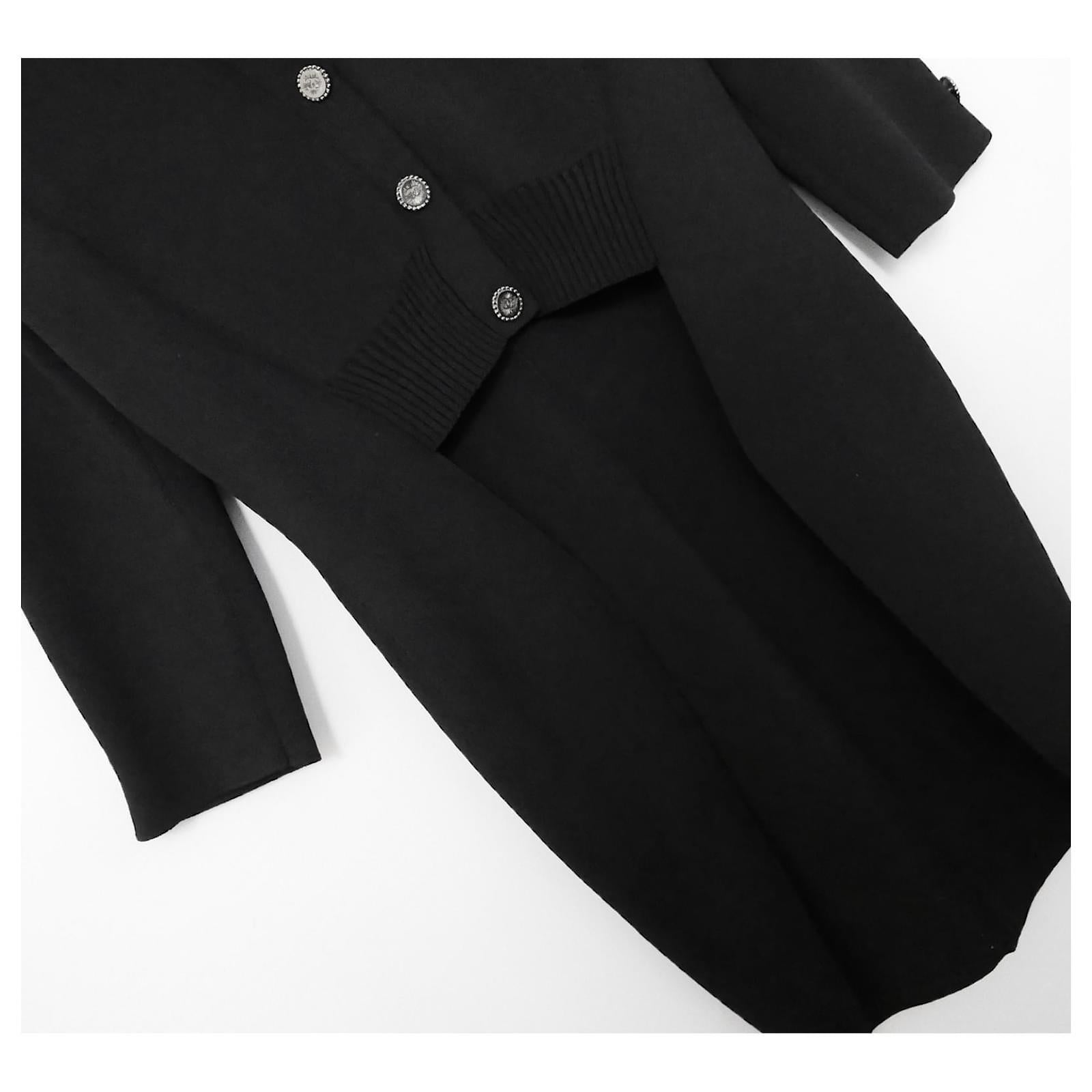 Relaxed chic knitted tailcoat jacket from the Chanel Resort 2011 Paris-St Tropez collection. unworn. Made from a smooth black viscose/polyester mix knit with small collar, three quarter sleeves and cut-away front. Has decorative metal CC buttons to