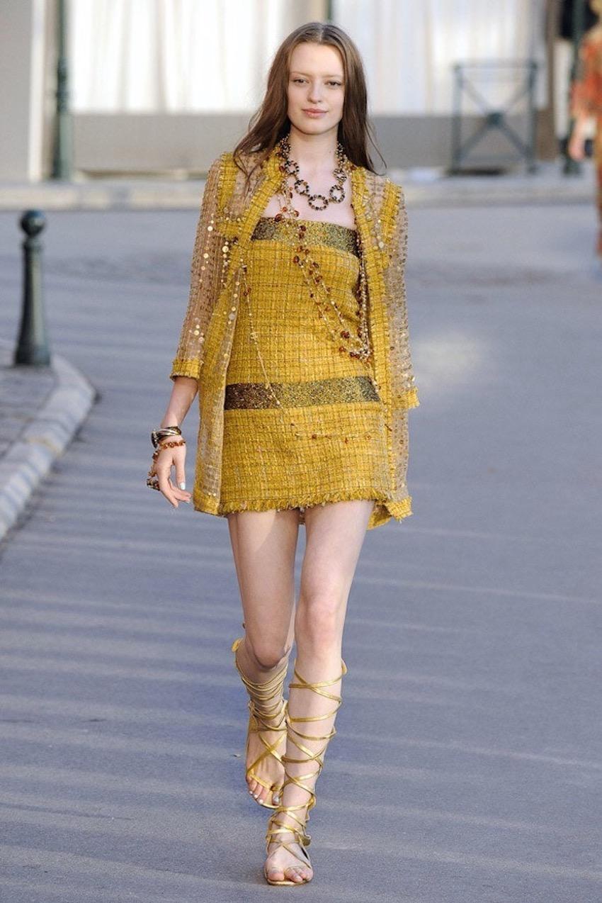Exquisite dress from the house of Chanel presented during the 2011 Resort Collection in the amazing setting of St Tropez - France.
Crafted in a beautiful Yellow Gold-tone Lesage Tweed with some crystal details on the straps, bustier and hips