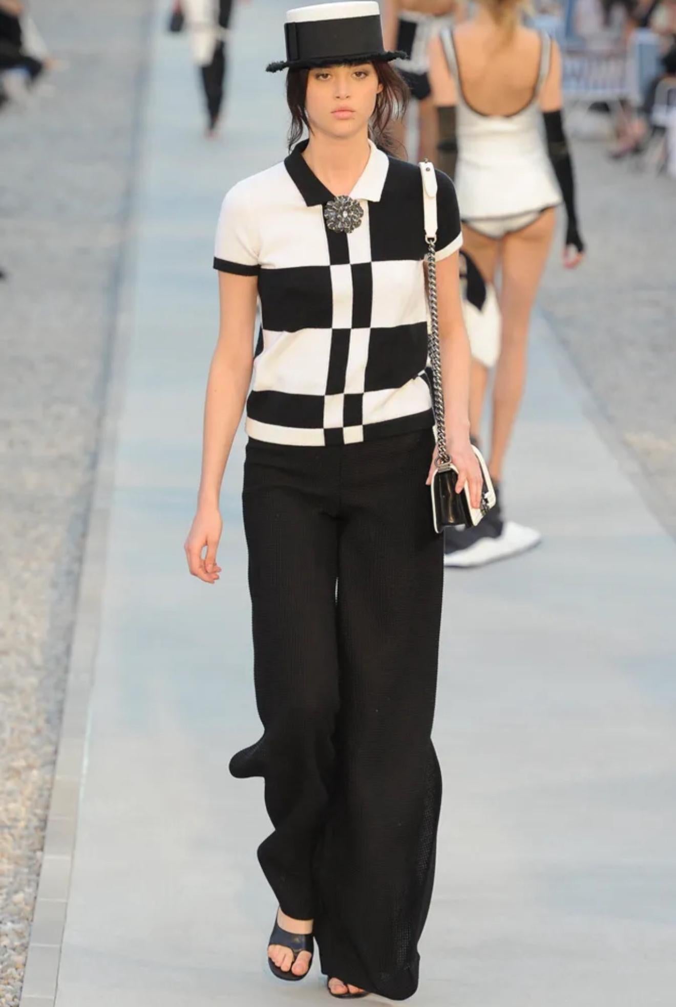 Chic Chanel, by Karl Lagerfeld, Resort 2012 Runway short sleeve cashmere sweater ! Features contrasting black and white stripes / squares. Simply slips over the head and stretches to fit. The most luxurious soft cashmere. 
In great unworn condition