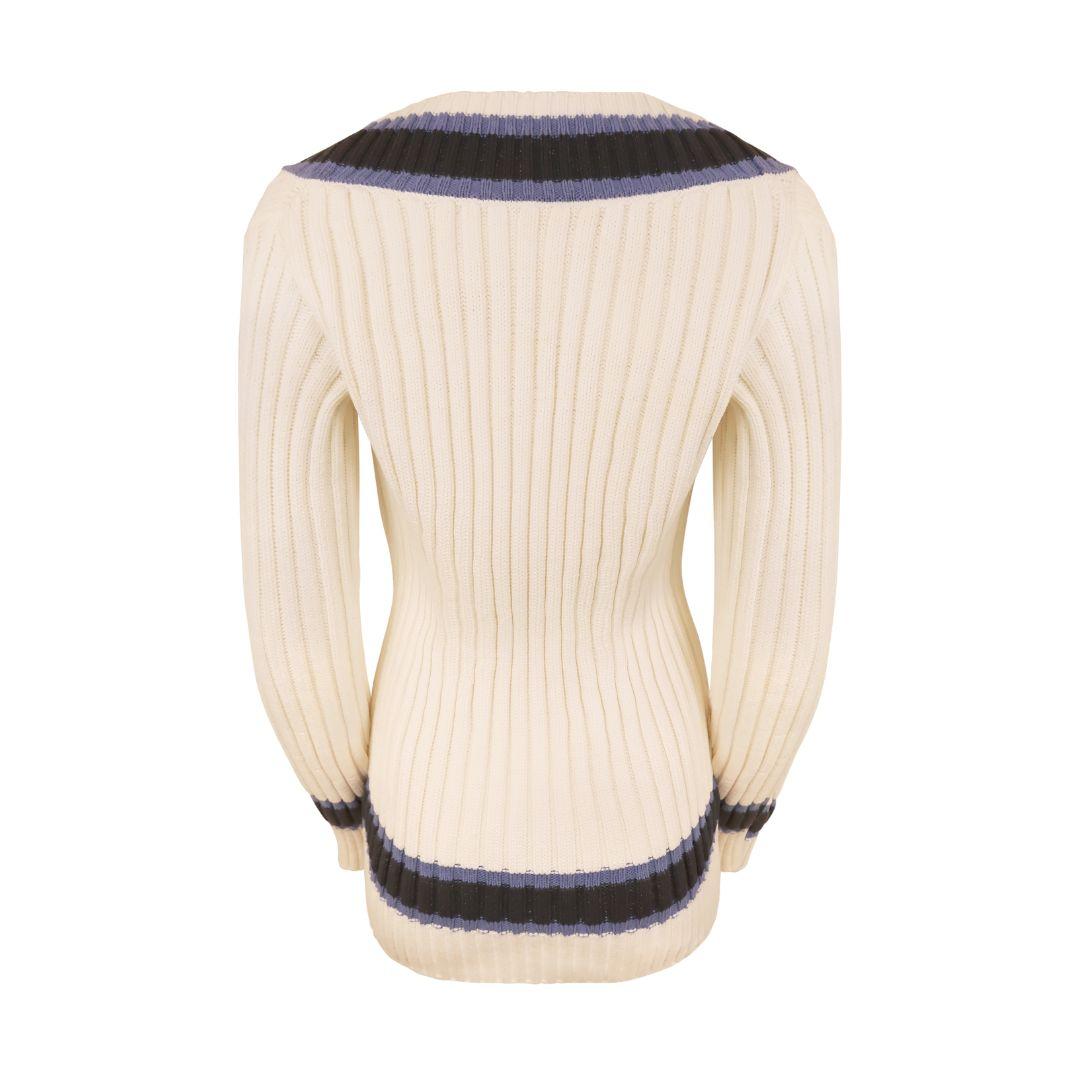 Preppy white Chanel deep V-neck varsity striped sweater as featured in the Resort 2014 runway collection.

Chunky rib knit with dual tone blue stripes at collar, cuffs and hem. Long length hits below the the hips. Front double welt pockets with