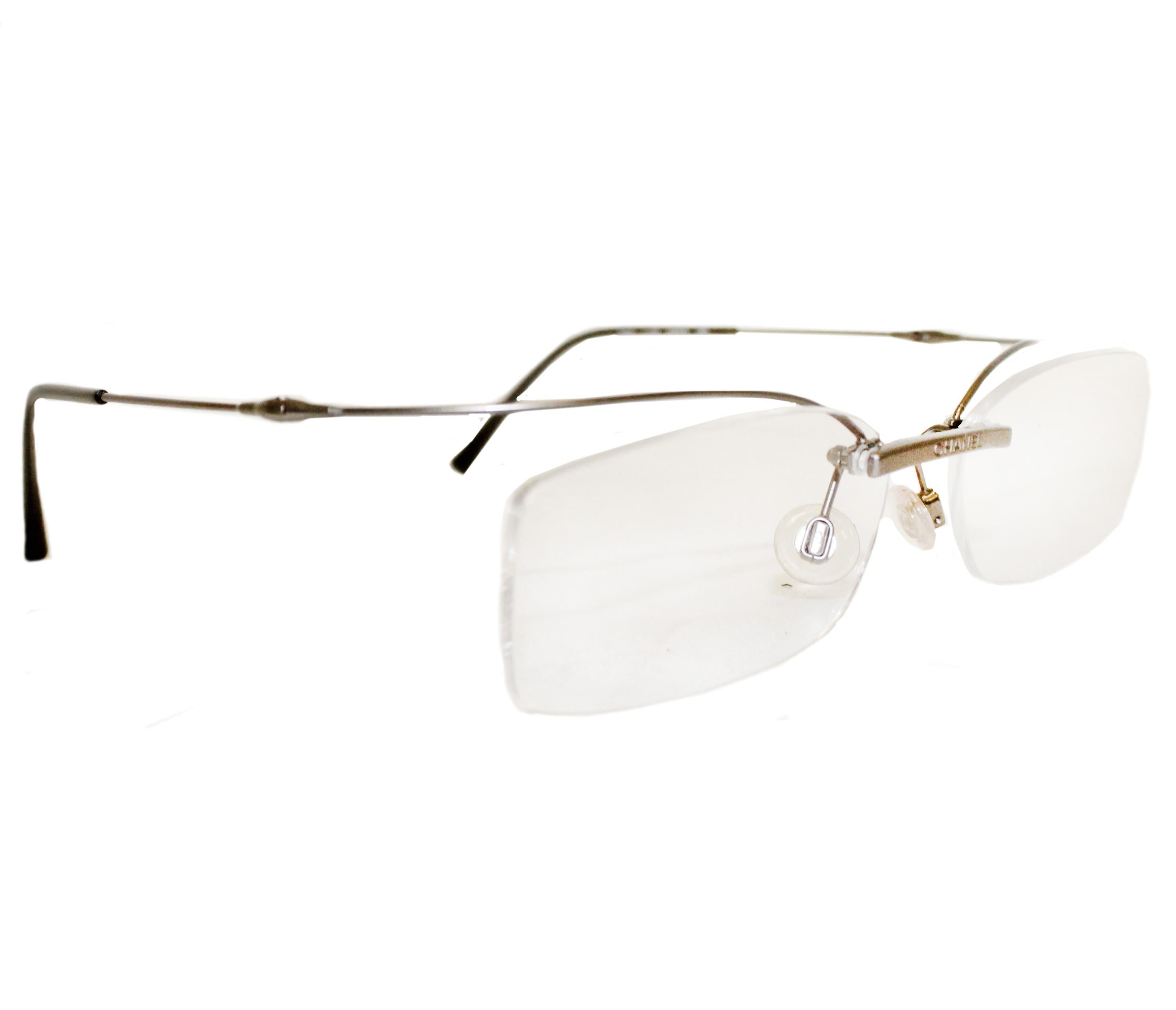 Chanel rimless metal temple 2033 C172 54 016 120 eyeglasses contain tremblant  floating temples in silver tone.   The lenses can be changed to your own prescription.  Glasses in excellent condition.  It comes with its own Chanel case.  Made in Italy.