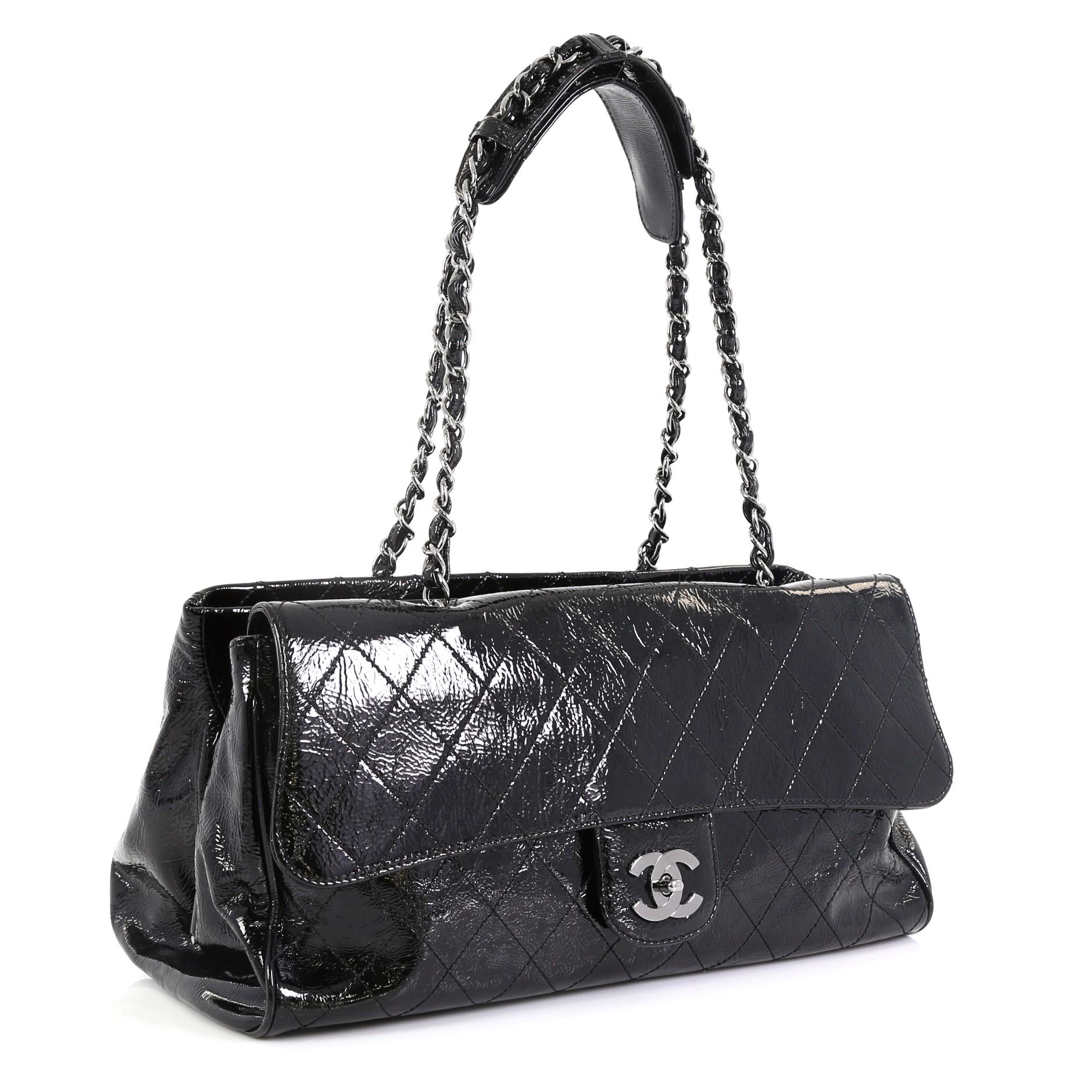 This Chanel Ritz Flap Bag Quilted Patent Largerafted from black diamond quilted patent leather, this oversized tote features dual woven-in leather chain straps with shoulder pads, an exterior flap compartment with CC turn-lock closure, a middle
