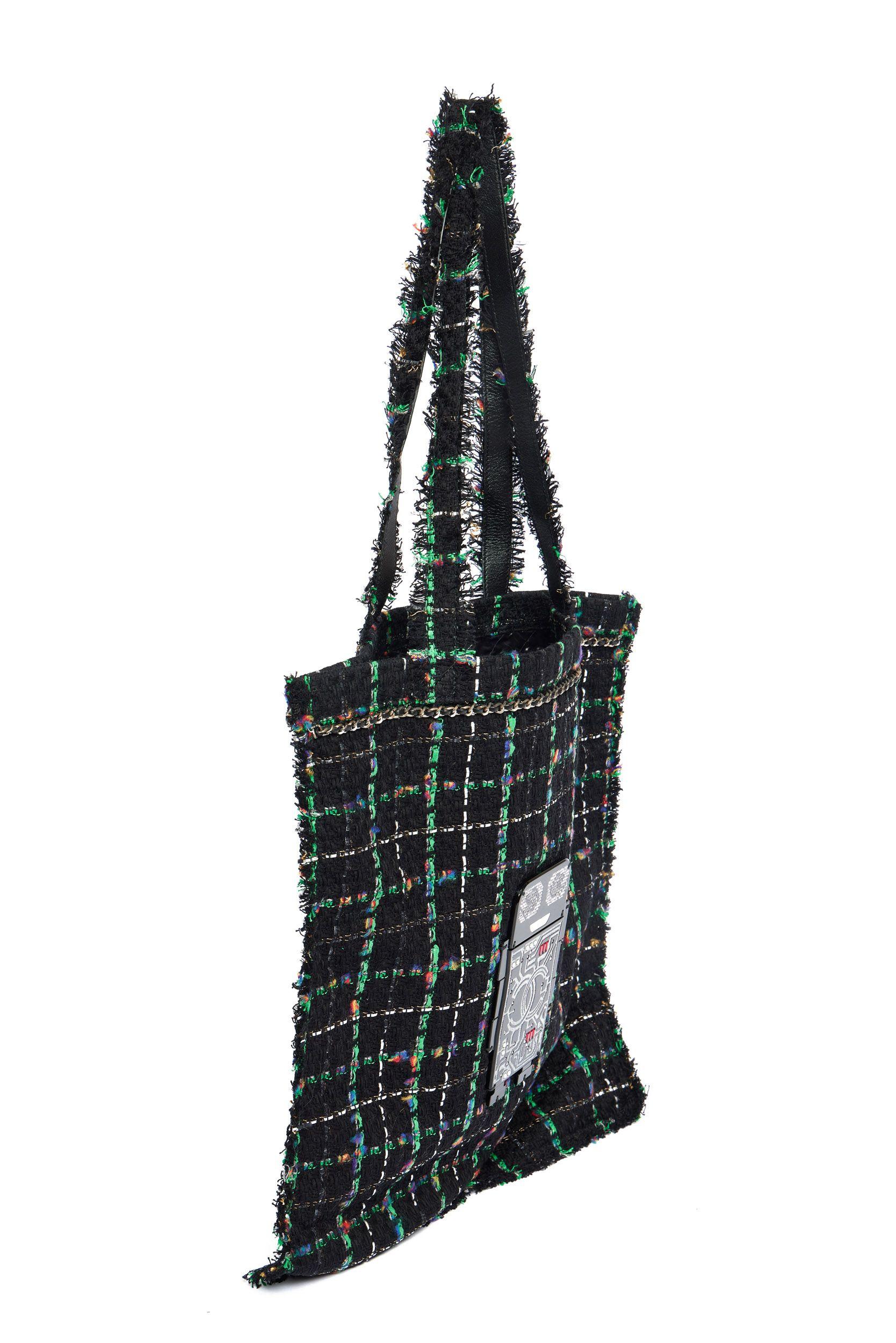 Chanel tote bag from the Robot Collection in black and green weaved tweed. On front of the bag is a robot attached whose body shows a big CC logo and his eyes are made of small rhinestones. The shoulder drop of the tweed and leather strap is 11’.