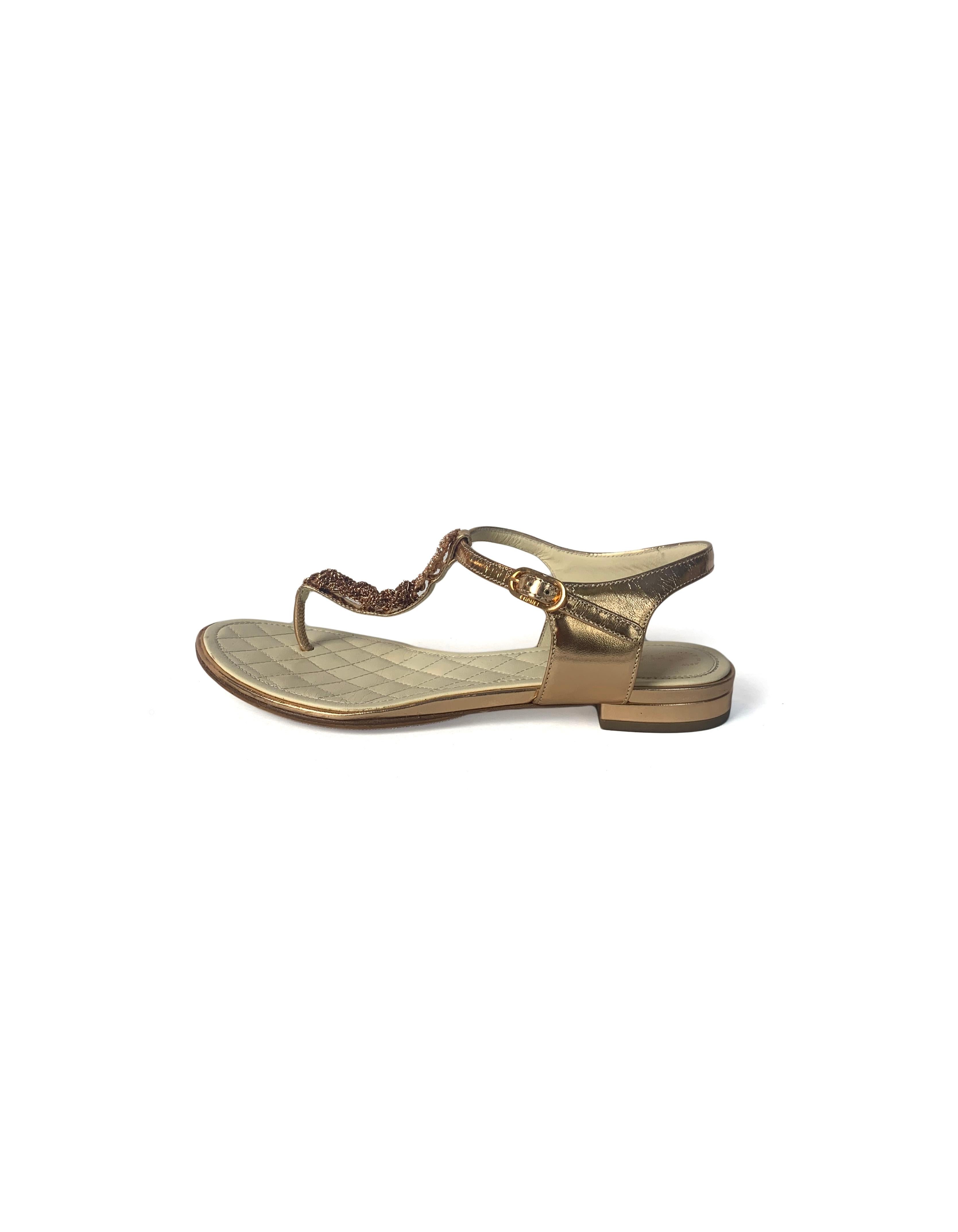 Chanel Rose Gold Thong Sandals.  Features braided chain-link detailing and crystal encrusted CC

Made In: Italy
Year of Production: 2015
Color: Rose gold
Hardware: Rose gold
Materials: Leather, metal, strass crystals
Closure/Opening: Adjustable