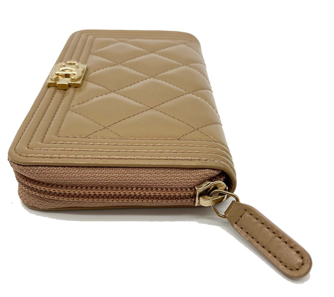 Chanel Rose Gold Patent Leather Le Boy Wallet in excellent condition. Quilted pearlized rose gold patent leather exterior in classic le boy style with full zip closure. tan leather and nylon interior with center zipped pocket and 4 side slit card