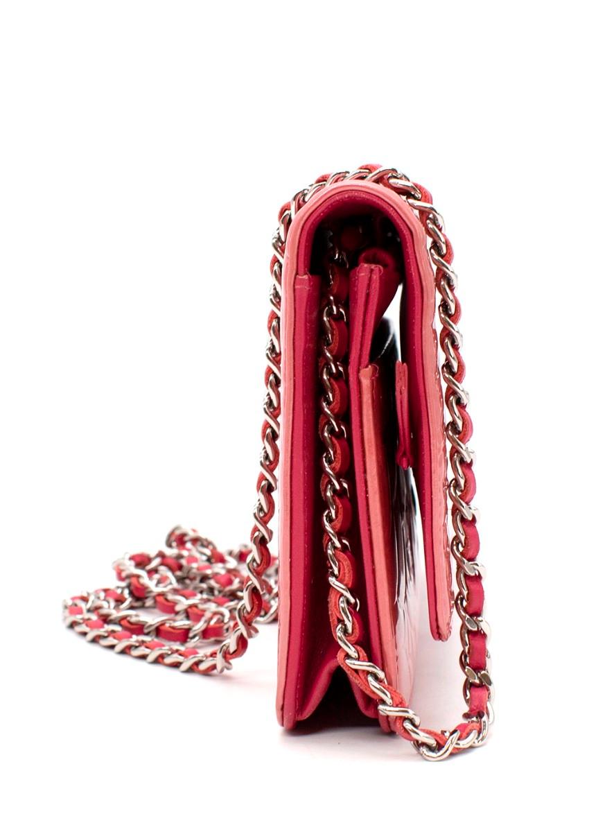Chanel Fuchsia Patent Camellia Embossed Leather Wallet on Chain
 
 
 
 - Rose pink camelia embossed patent
 
 - Snap-button closure to the flap
 
 - Opens to 6 card slots, 2 slip pockets and a zipped coin pouch
 
 - Silver-tone hardware
 
 
 
