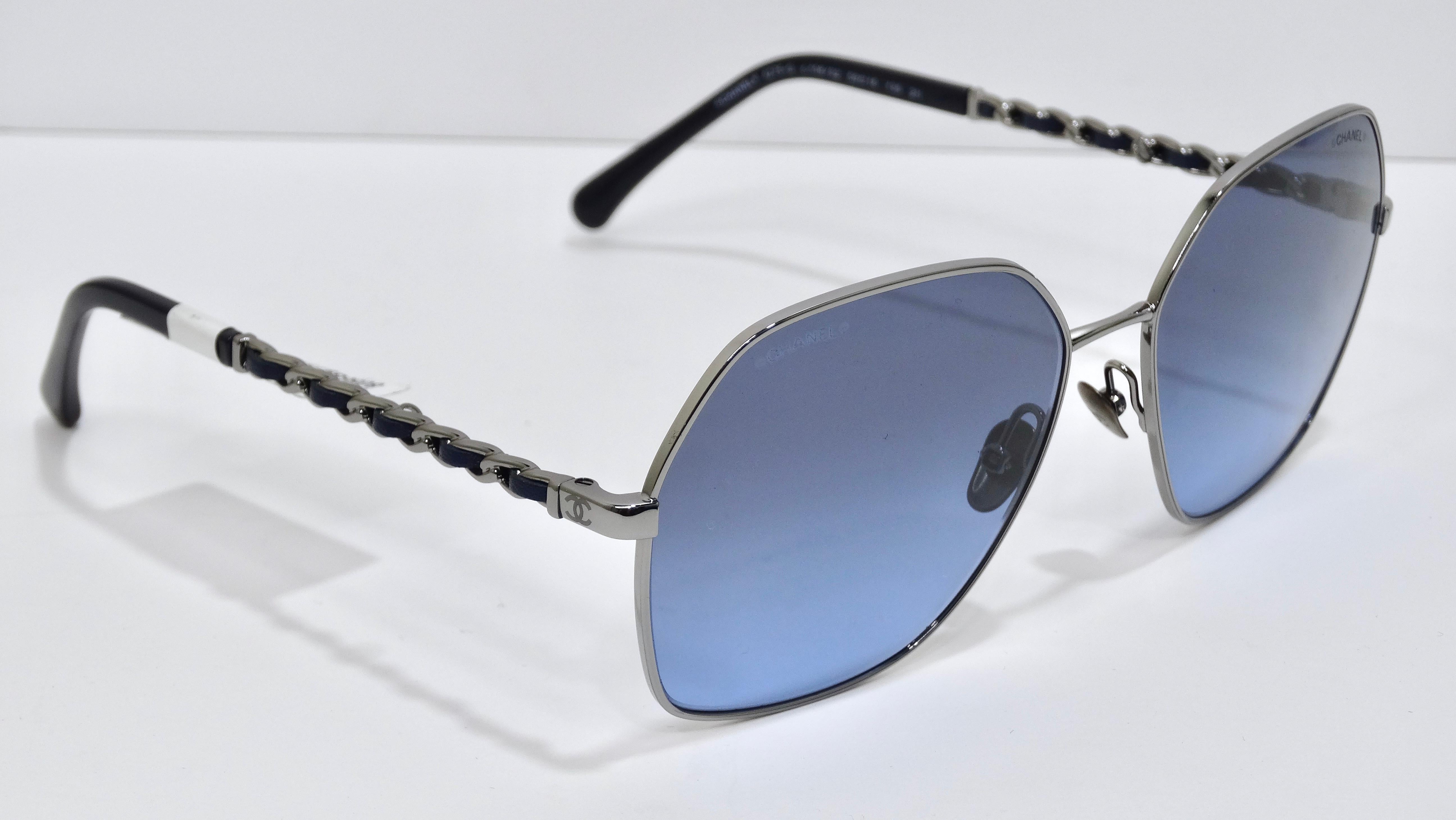 These sunglasses belong in your collection! These are brand NEW Chanel sunglasses, with the tags still attached. They are made with a sleek dark silver metal and blue gradient lenses. This unique pair of sunglasses comes with a removable