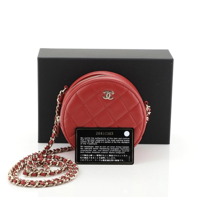This Chanel Round Clutch with Chain Quilted Caviar Mini, crafted from red quilted caviar leather, features woven-in leather chain strap and gold-tone hardware. Its zip closure opens to a red fabric interior with slip pocket. Hologram sticker reads: