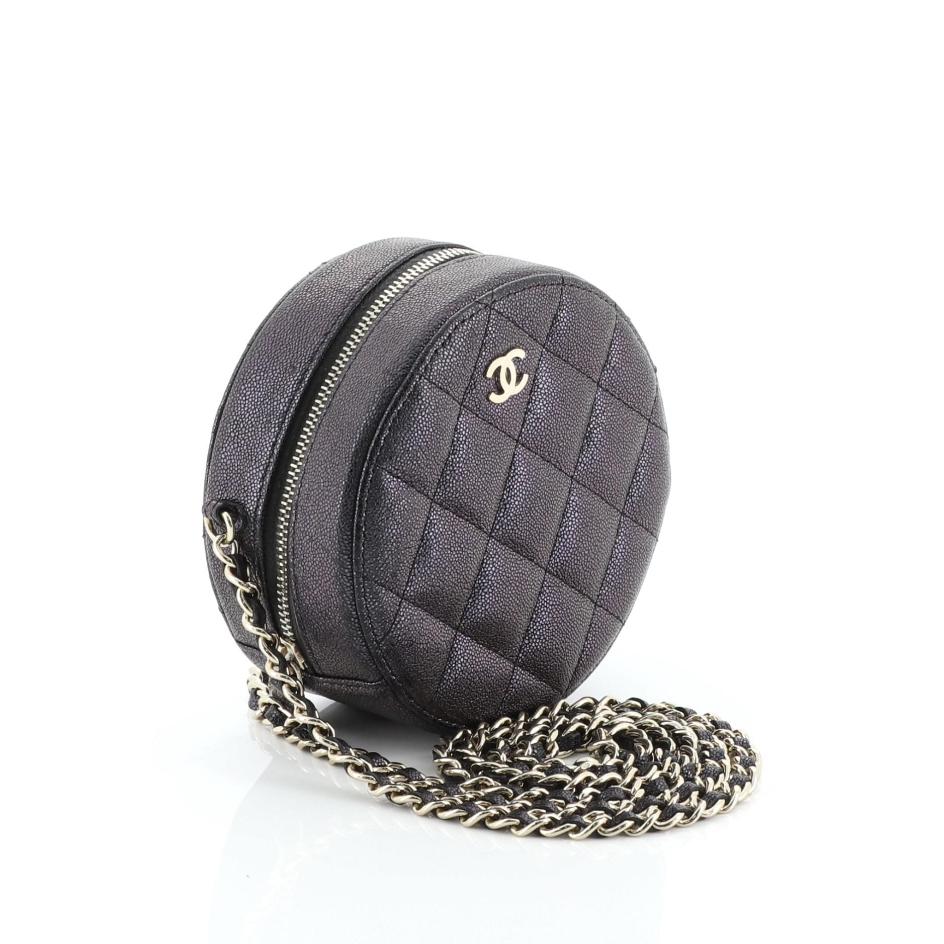 This Chanel Round Clutch with Chain Quilted Caviar Mini, crafted from green, purple and multicolor quilted caviar leather, features woven-in leather chain strap and gold-tone hardware. Its zip closure opens to a black fabric interior with slip