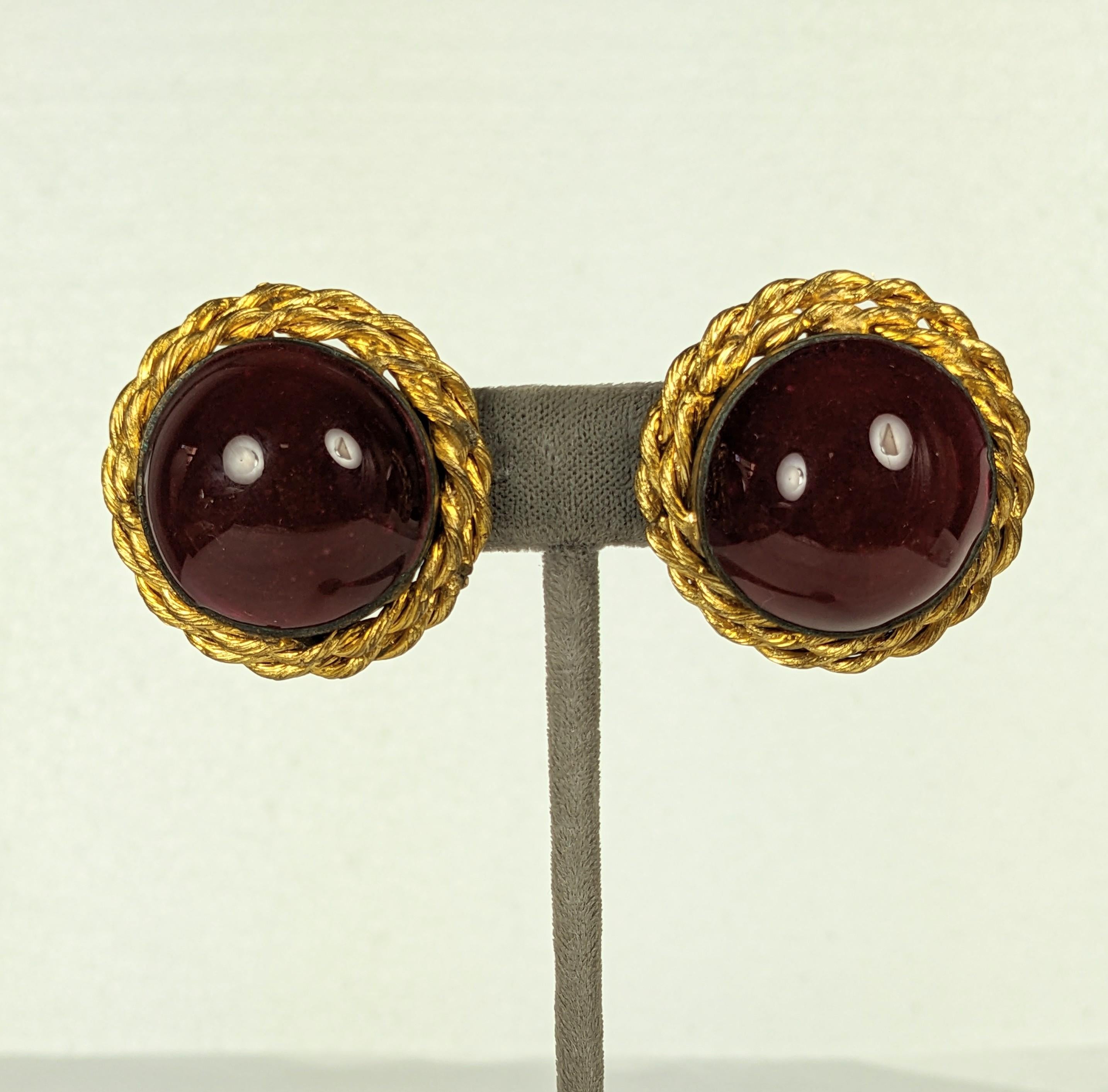 Large and striking Chanel Ruby Poured Glass Earrings, Maison Gripoix from the 1980's. Unsigned runway samples of ruby poured glass for Chanel. Handmade with gilt bronze twisted surround. 1 3/8