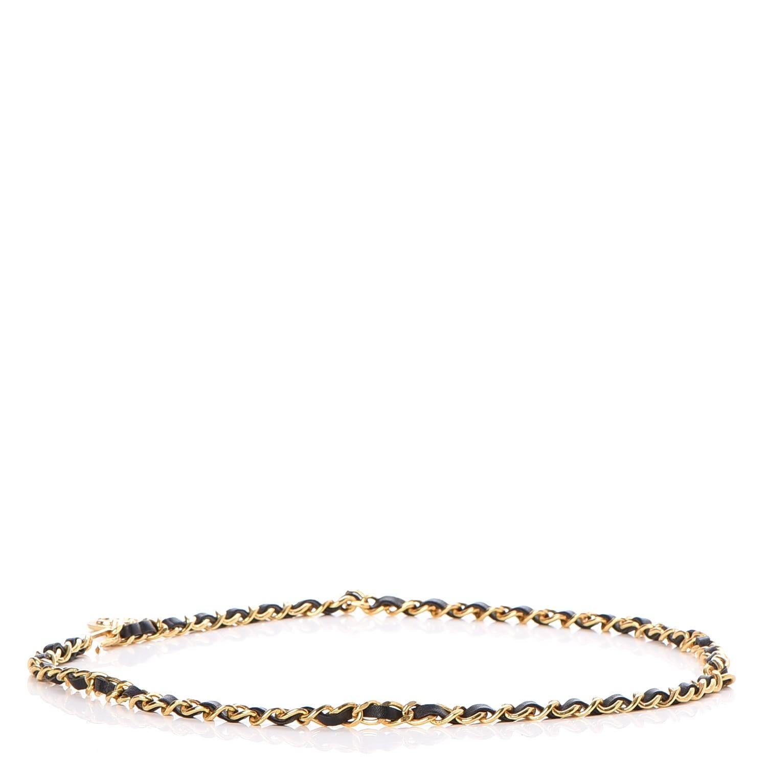 Chanel gold tone chain interlaced with black Leather and features a medallion with 31 Rue Cambon Paris engraved.

COLOR: Gold and black
MATERIAL: Metal and leather
MEASURES: Length of chain 37.5”. Medallion diameter 1.2”.
COMES WITH: Chanel box.