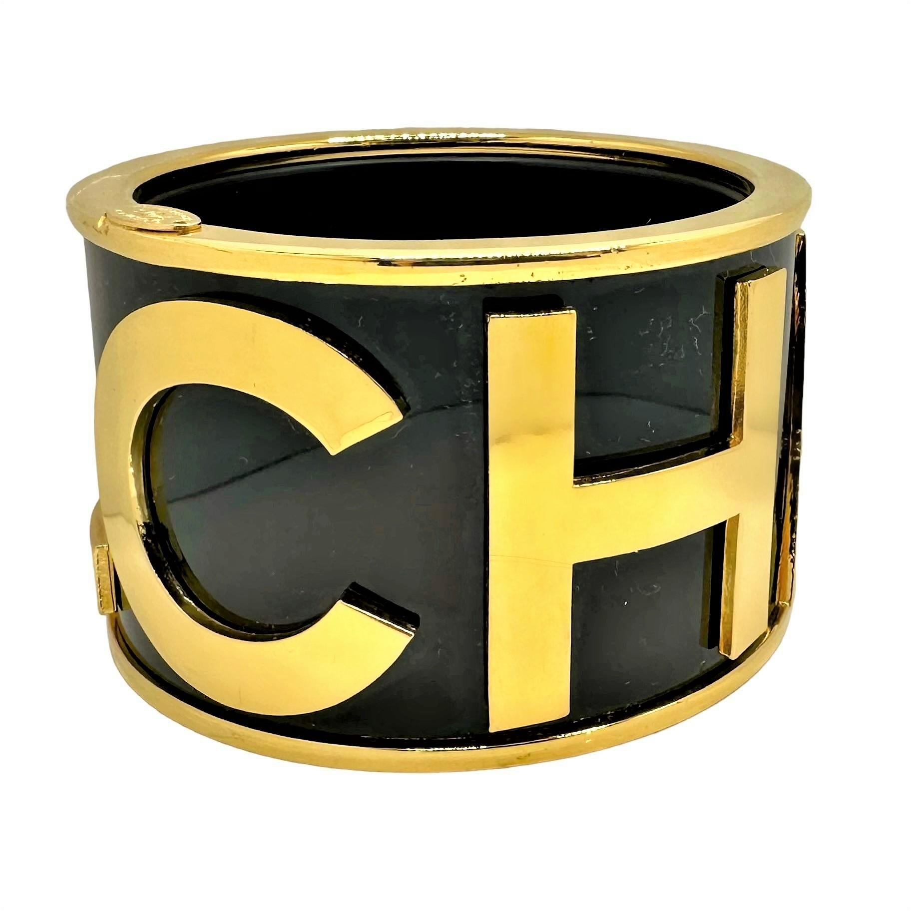 Made for Chanel Runway Season 23, this large size cuff/bangle is one of the most sought after iconic Chanel bracelets. The black background is accented with 1 1/2 inch high gold tone letters spelling out the word CHANEL. The top and bottom edges are