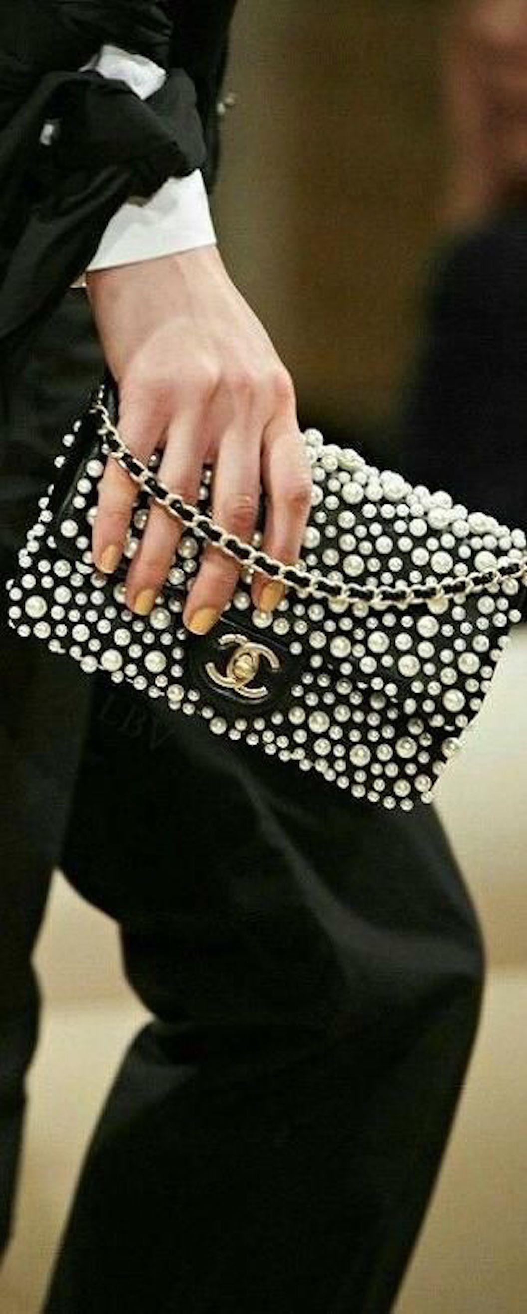 Add a Piece of the Chanel Runway to Your Life.

Straight off the 2015 Chanel Runway, this chic leather and faux pearl flap bag is a queen among princesses.  Produced by Chanel in limited quantities, it is the ideal addition to a serious Chanel