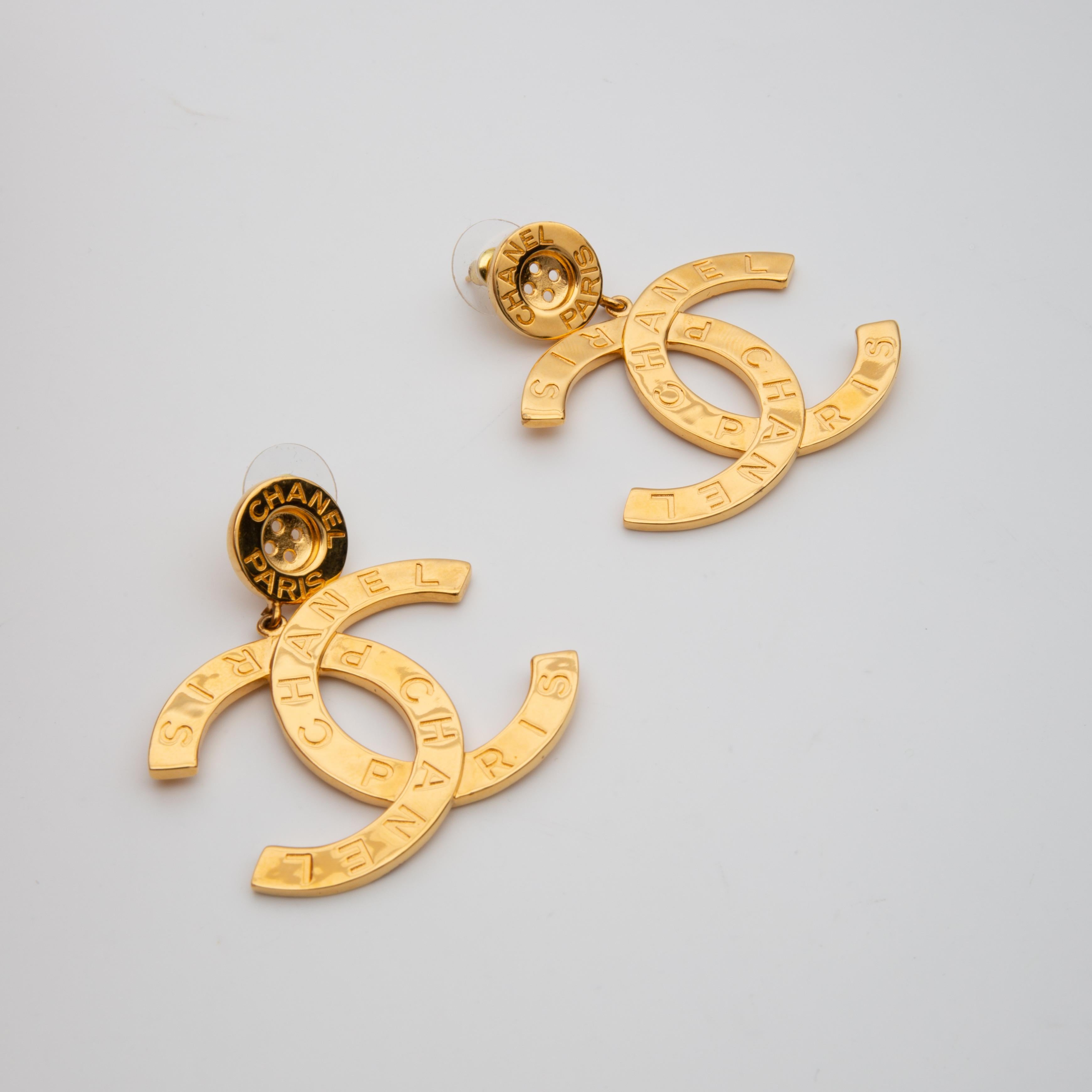 This stunning and classic Chanel earrings feature large CC with an gold tone metal engraved with 