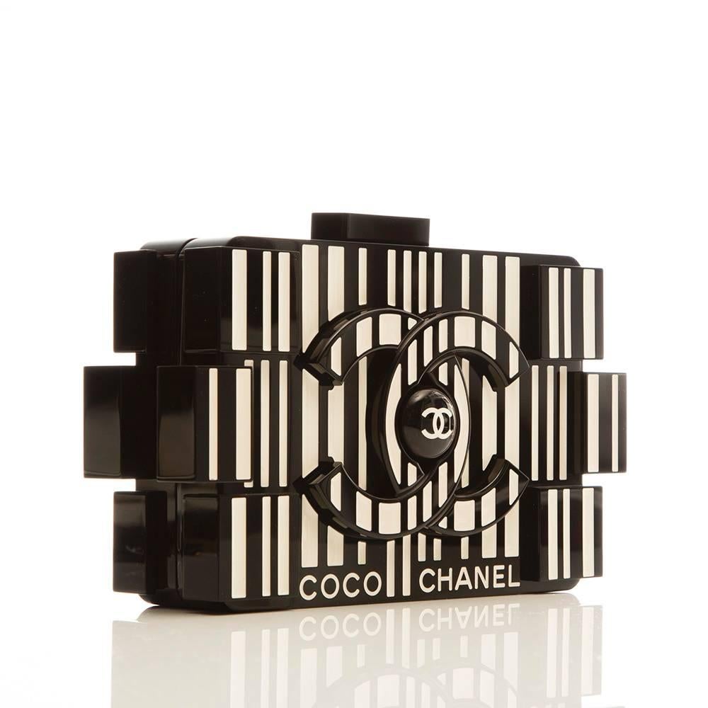 Chanel's playful lego clutch gets a barcode treatment. This rare and collectable clutch bag is formed of plexiglass patterned with a striking Op-art graphic on one side and it's done so in Coco Chanel's favourite two colours: ivory and black.