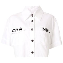 Chanel Runway White Cotton Black 'CHANEL' Short Sleeve Button Collar Shirt  at 1stDibs | chanel shirt, chanel white shirt, chanel top