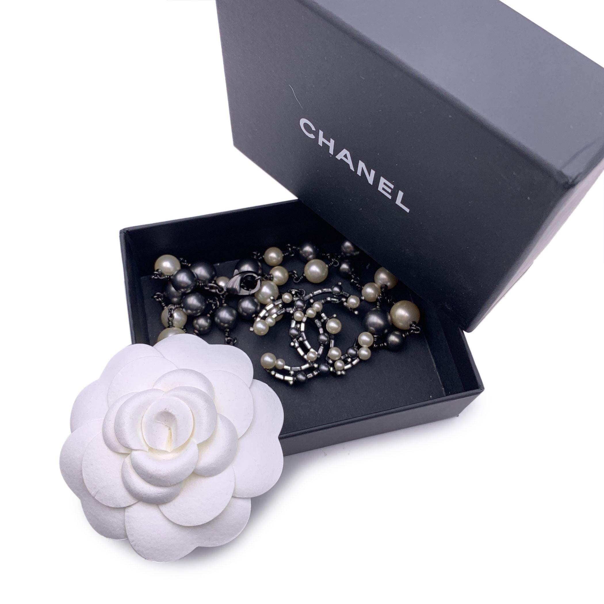 Lovely Chanel necklace with rutherium chain and faux pearls and black ceads. It features a CC logo pendant with faux pearls, baguette crystals and black beads. Lobster closure. Total length of the chain: 23.5 inches - 59.6 cm. 'CHANEL B10 CC A -