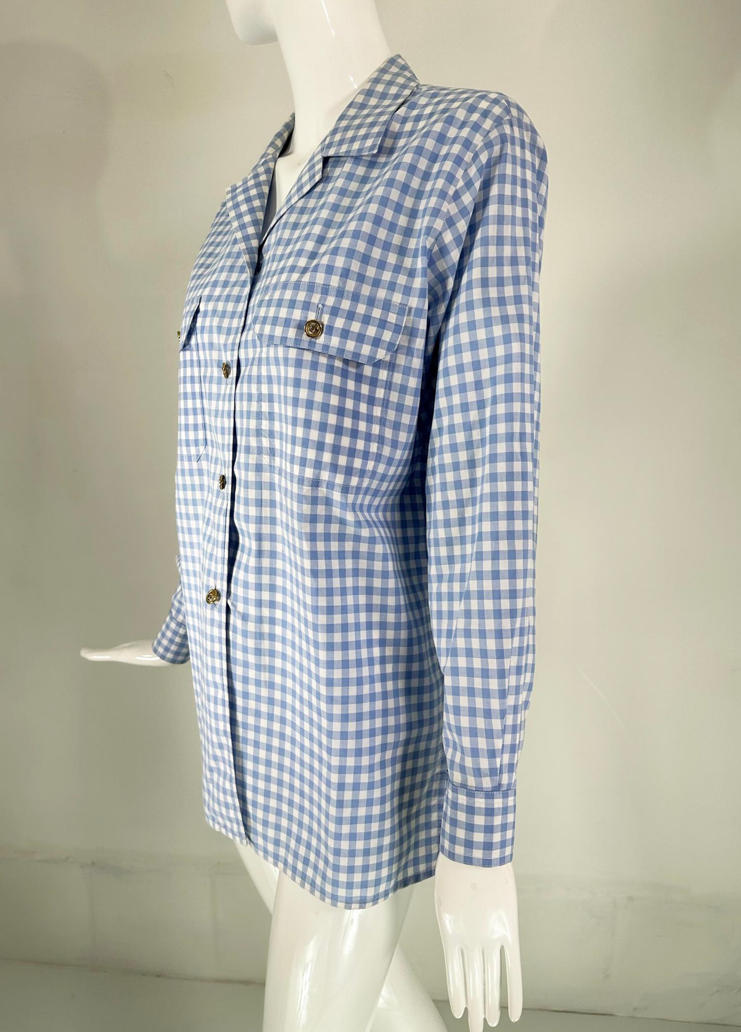 Chanel S/S 1995 blue & white gingham check blouse. Long sleeves with Chanel embroidered on each sleeve wrist. The over size blouse closes at the front with gold Chanel buttons, there are Chanel buttons at each wrist & Chanel button closures at each