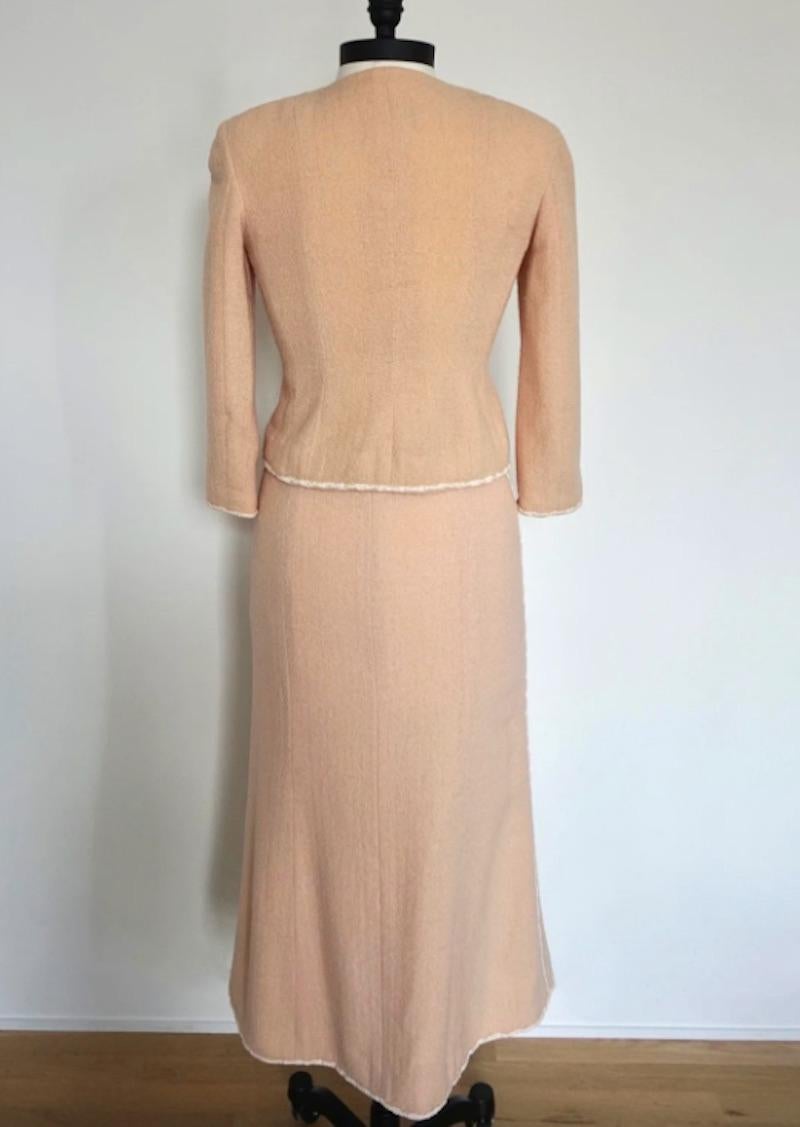 Chanel S/S 1999 Midi Skirt Suit. Beautifully crafted tweed skirt suit in an adorable peach color. Classic & timeless design from a memorable collection by Karl Lagerfeld. 

Jacket

Shoulders 17.5 in
Bust 34 in
Waist 29 in
Sleeve 19.5 in
Length 20