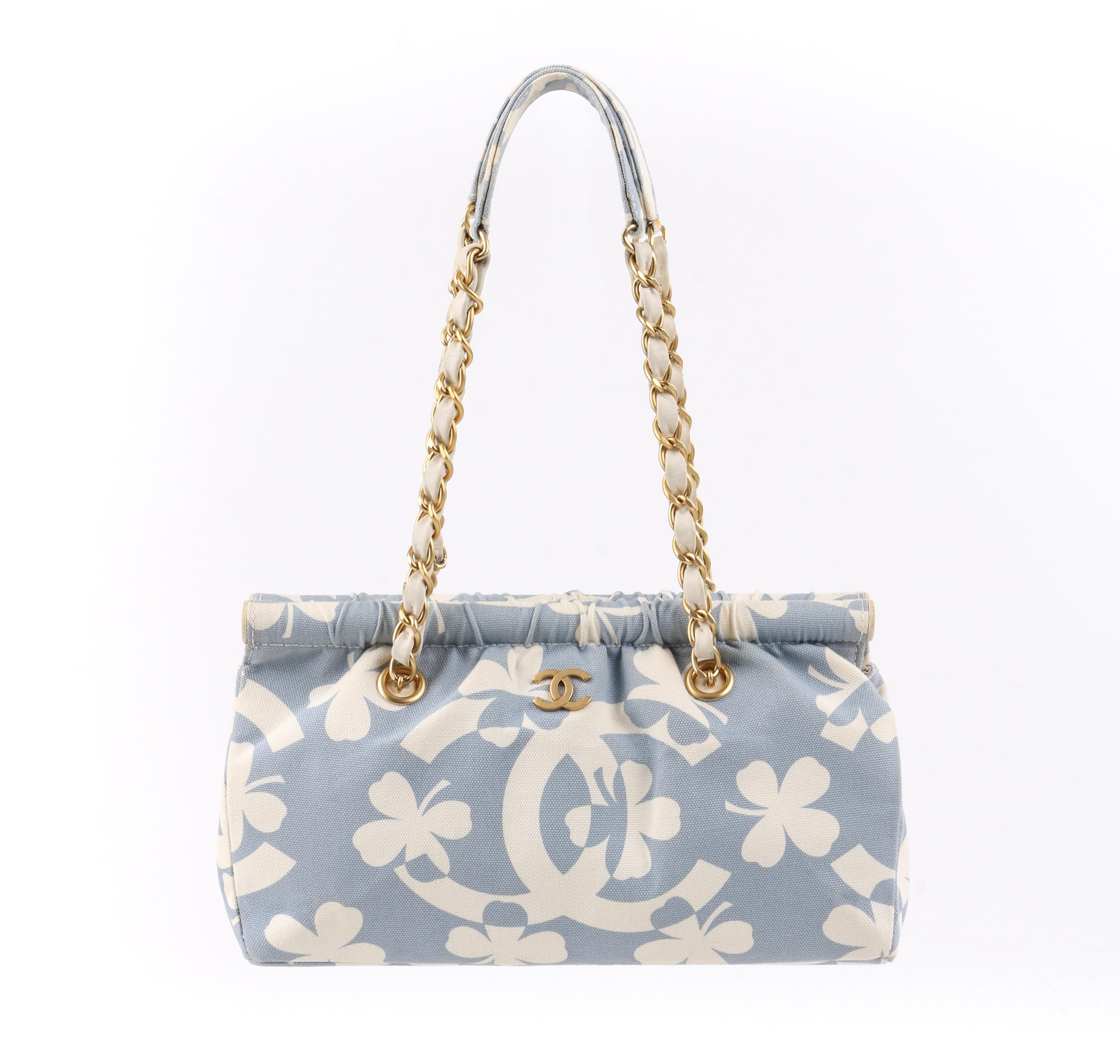 DESCRIPTION: CHANEL S/S 2004 Powder Blue Four Leaf Clover Canvas Chain Handle Purse w/ Wallet
 
Brand / Manufacturer: Chanel
Collection: Spring / Summer 2004
Designer: Karl Lagerfeld
Manufacturer Style Name: 
Style: Chain handle purse with