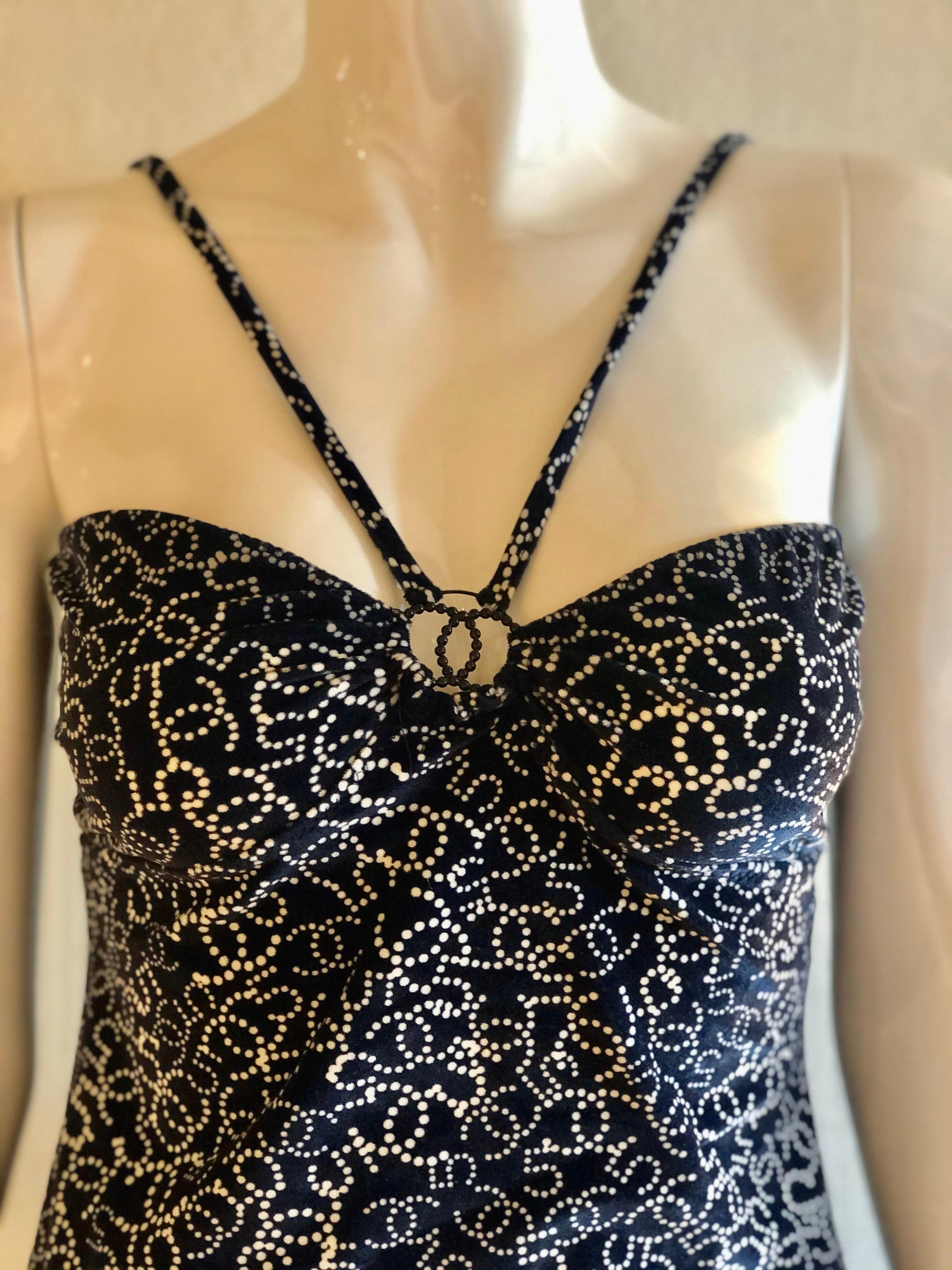 Say hello to the perfect midnight blue and cream Chanel velour camisole with interlocking CC logo/Number 5 print throughout, featuring beaded interlocking CC hardware. Hook closure in the back. This piece is from Chanel's Spring 2006 Collection. Sz