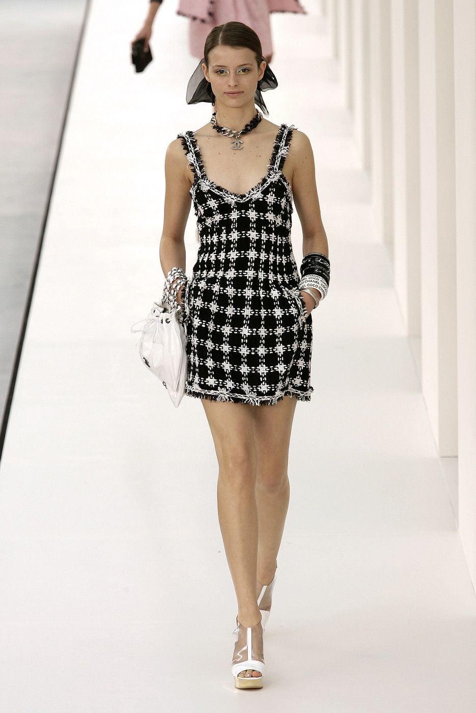 Dating to the S/S 2007 collection, this Karl Lagerfeld designed mini dress appeared on the runway that season. A classic piece that screams Chanel, this is made of black & white woven tweed in a lightweight cotton blend with frayed trim detail at