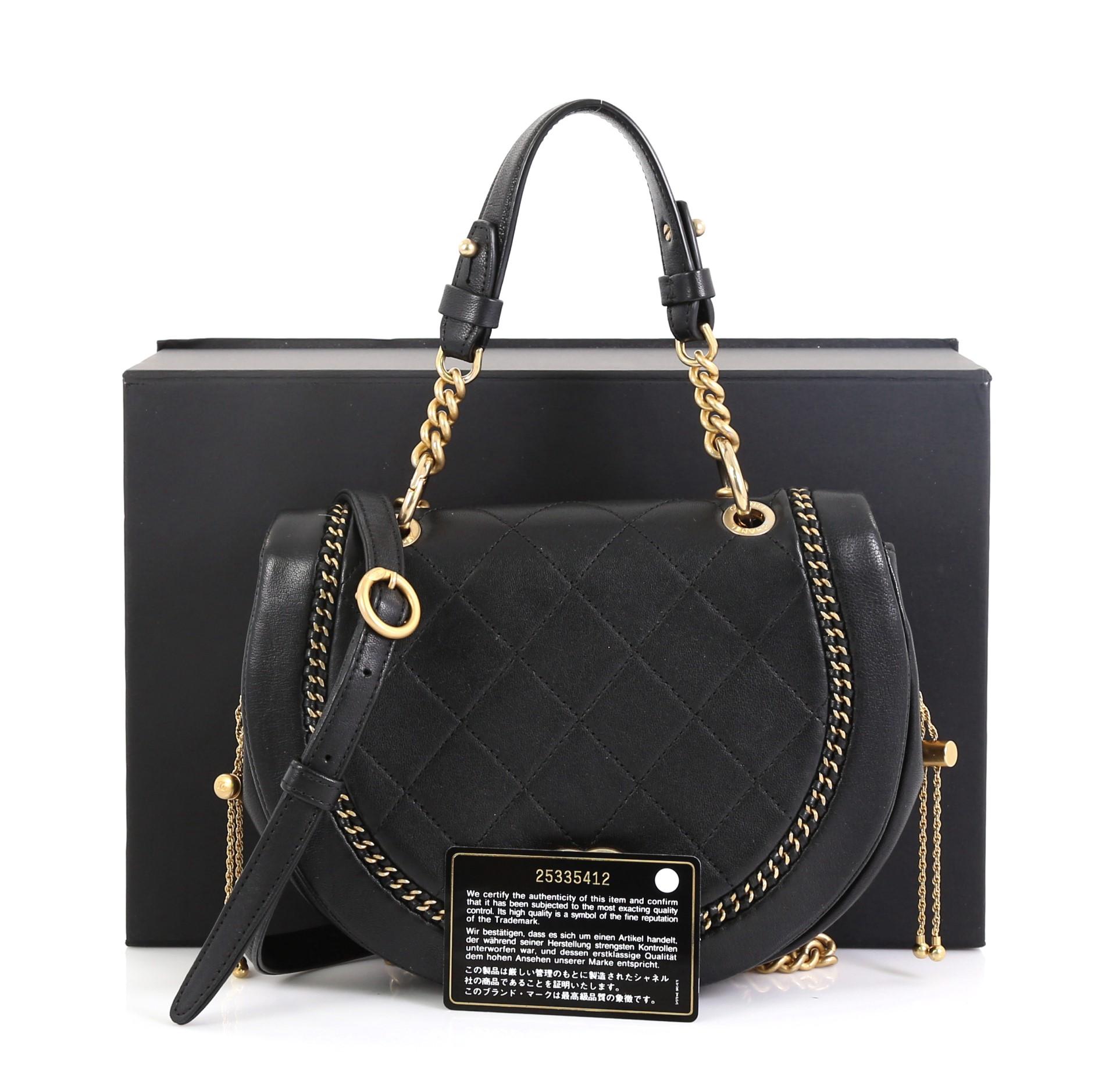 This Chanel Saddle Bag Quilted Leather with Chain Detail Small, crafted in black quilted leather, features leather top handle, chain detail and gold-tone hardware. Its CC turn-lock closure opens to a black fabric interior. Hologram sticker reads: