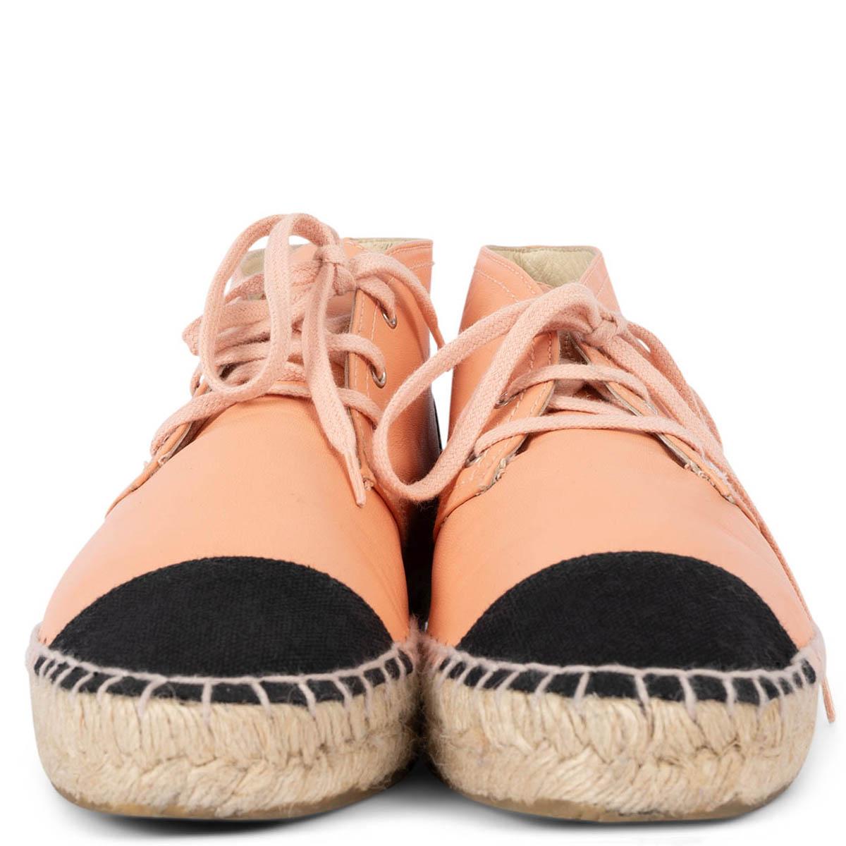 100% authentic Chanel high-top espadrilles in smooth salmon pink lambskin with black canvas heel and cap-toe. Have been worn once or twice and are in excellent condition. 

2015 Paris-Dubai Resort

Measurements
Model	15C G29600
Imprinted