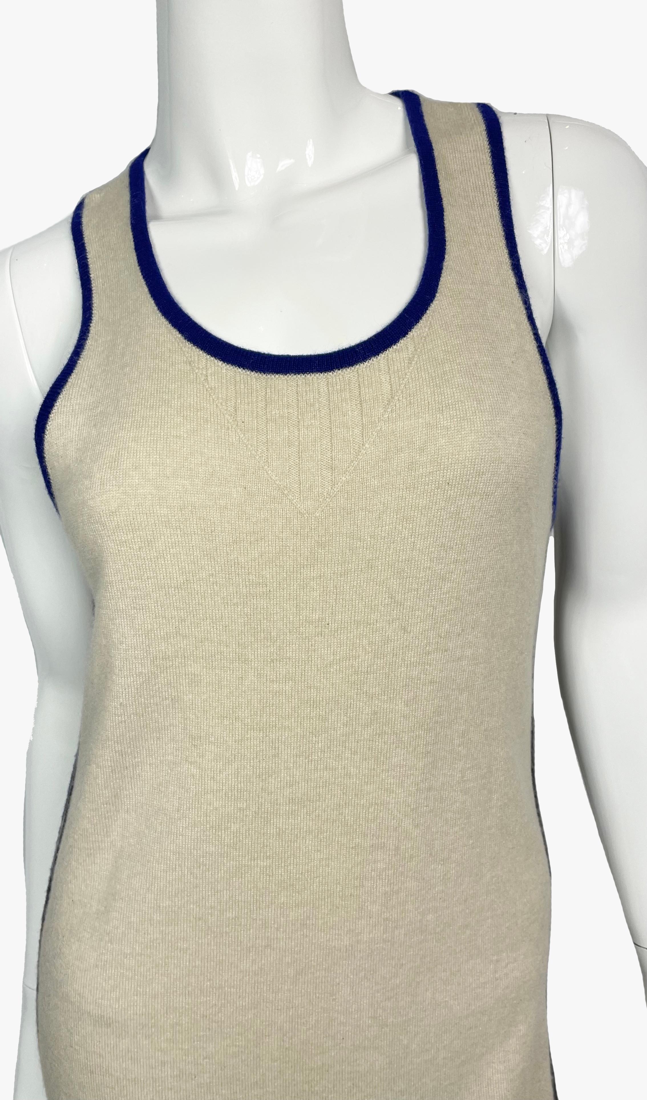 Chanel sand color cashmere tank dress with blue piping and a kangaroo pocket. 
CC logo at the back. 
Period: early 2010s
Size: FR 36
Overall length - 91 cm
Height from shoulder to armpit - 25 cm
Armpit to Armpit - 36 cm
Waist - 78 cm
Hips - 82